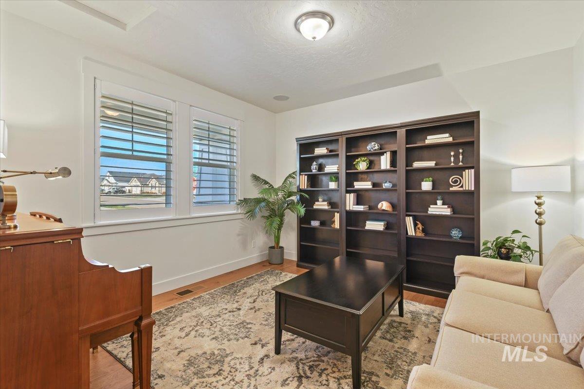 Living area with light wood-type flooring and a textured ceiling