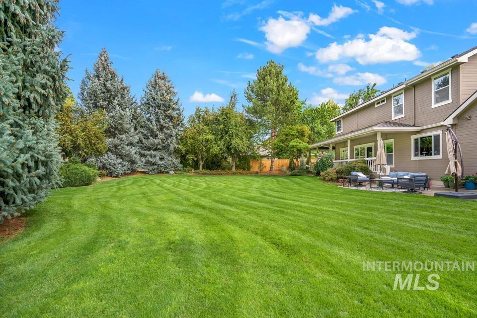 View of yard featuring an outdoor living space, a patio, and view of scattered trees