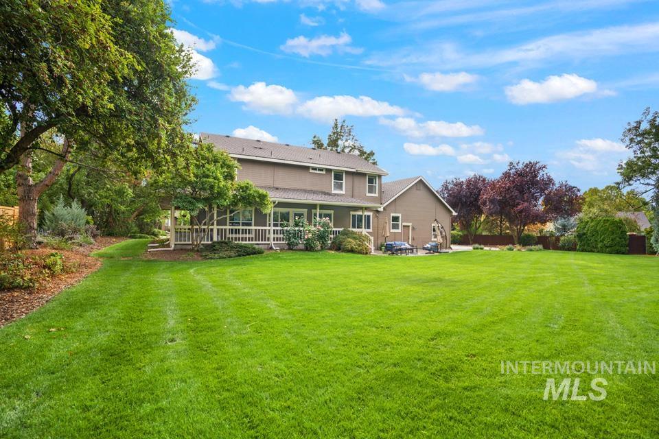 Back of property with a yard and a porch