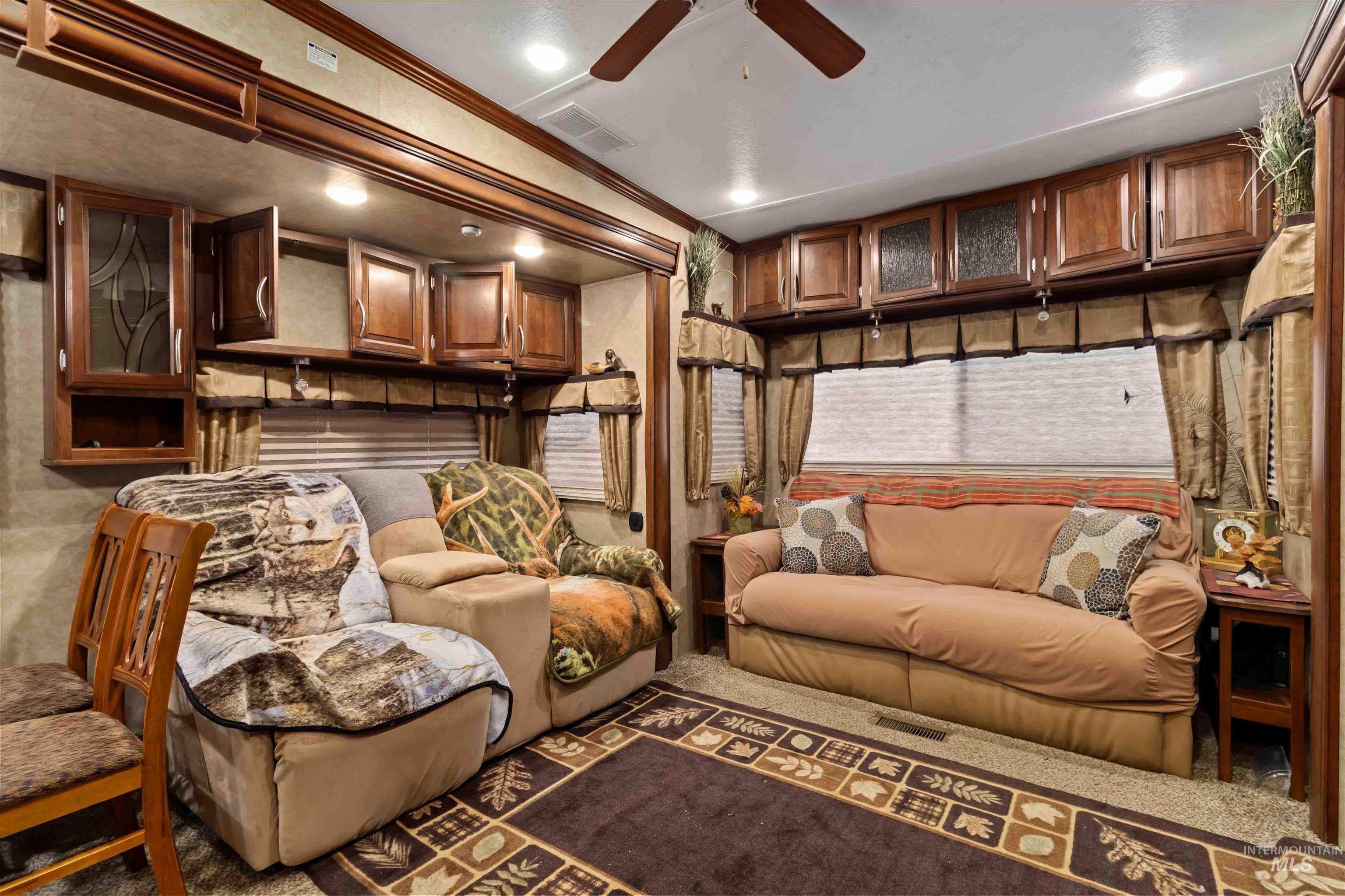 Sitting room featuring ornamental molding, carpet, a ceiling fan, and recessed lighting
