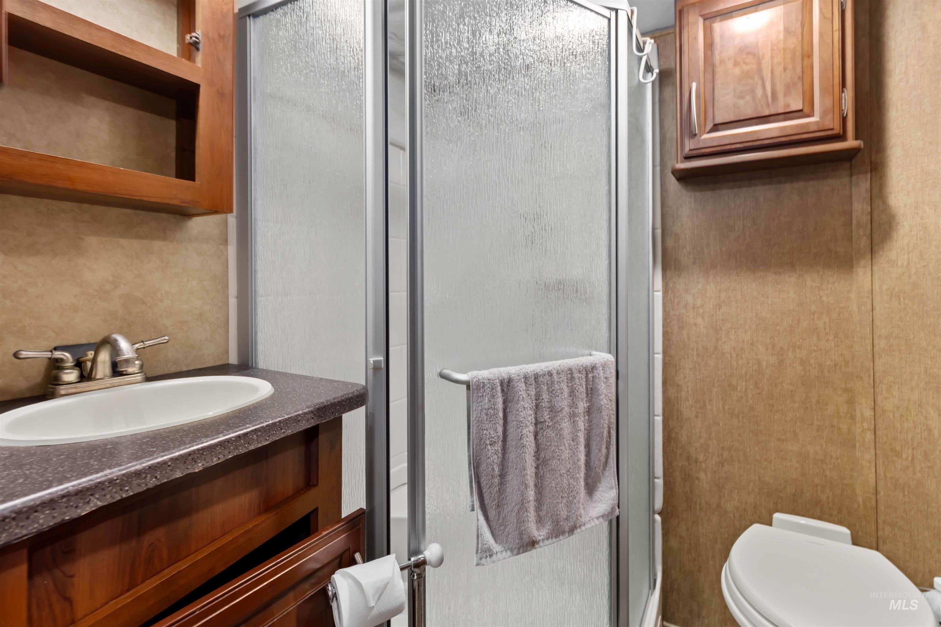 Bathroom with vanity and a shower stall