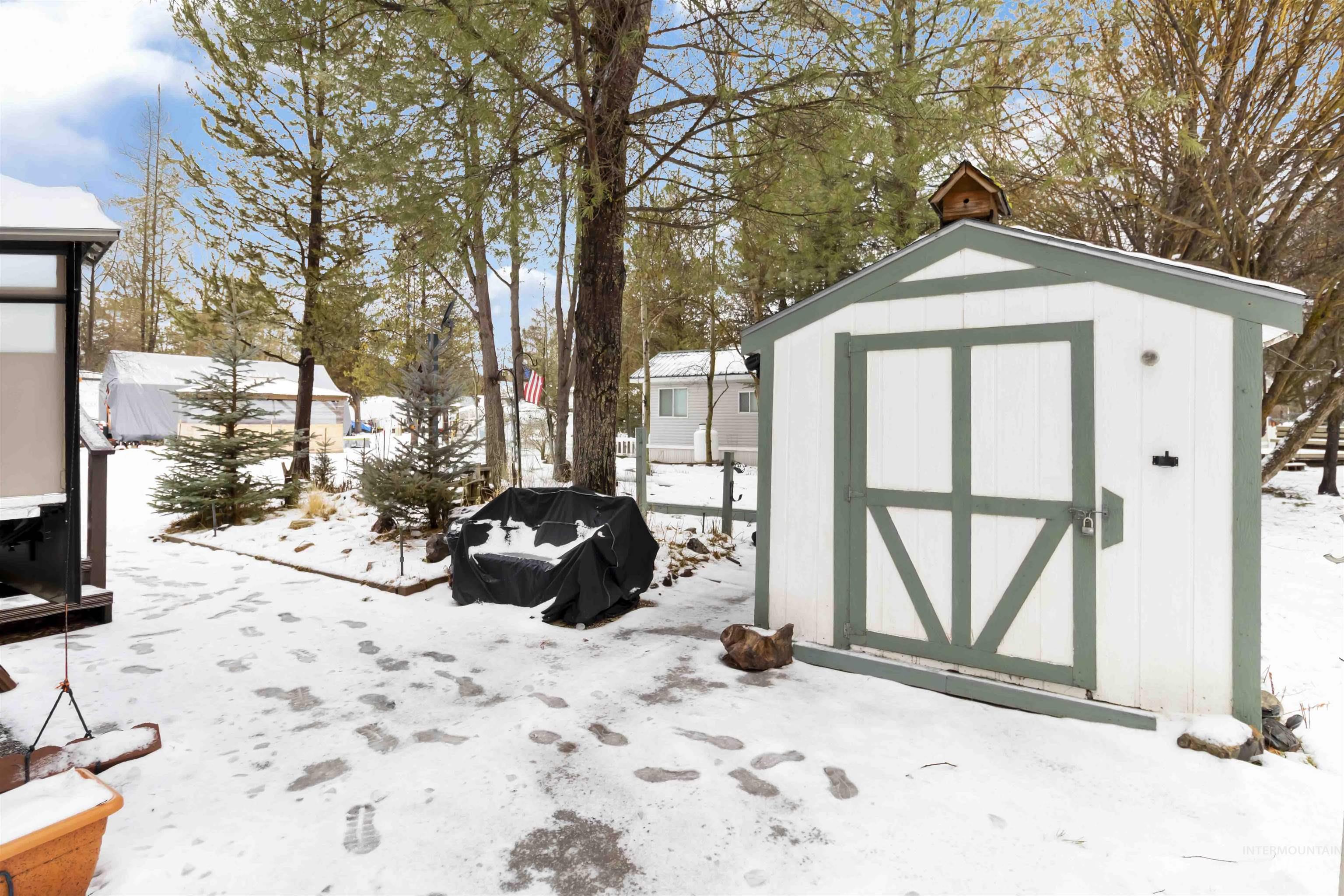 Snow covered structure with a storage shed