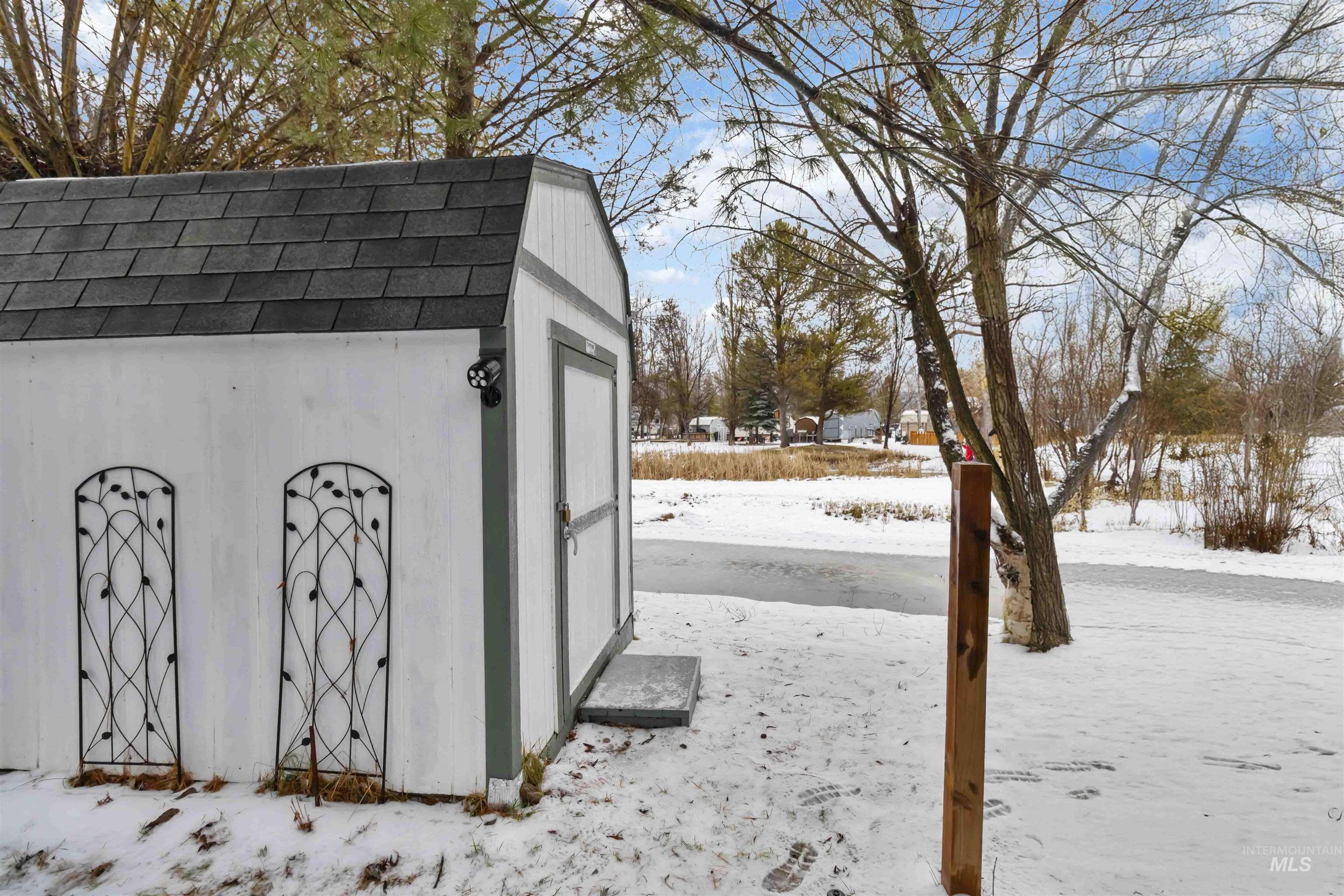 Snow covered structure with a shed