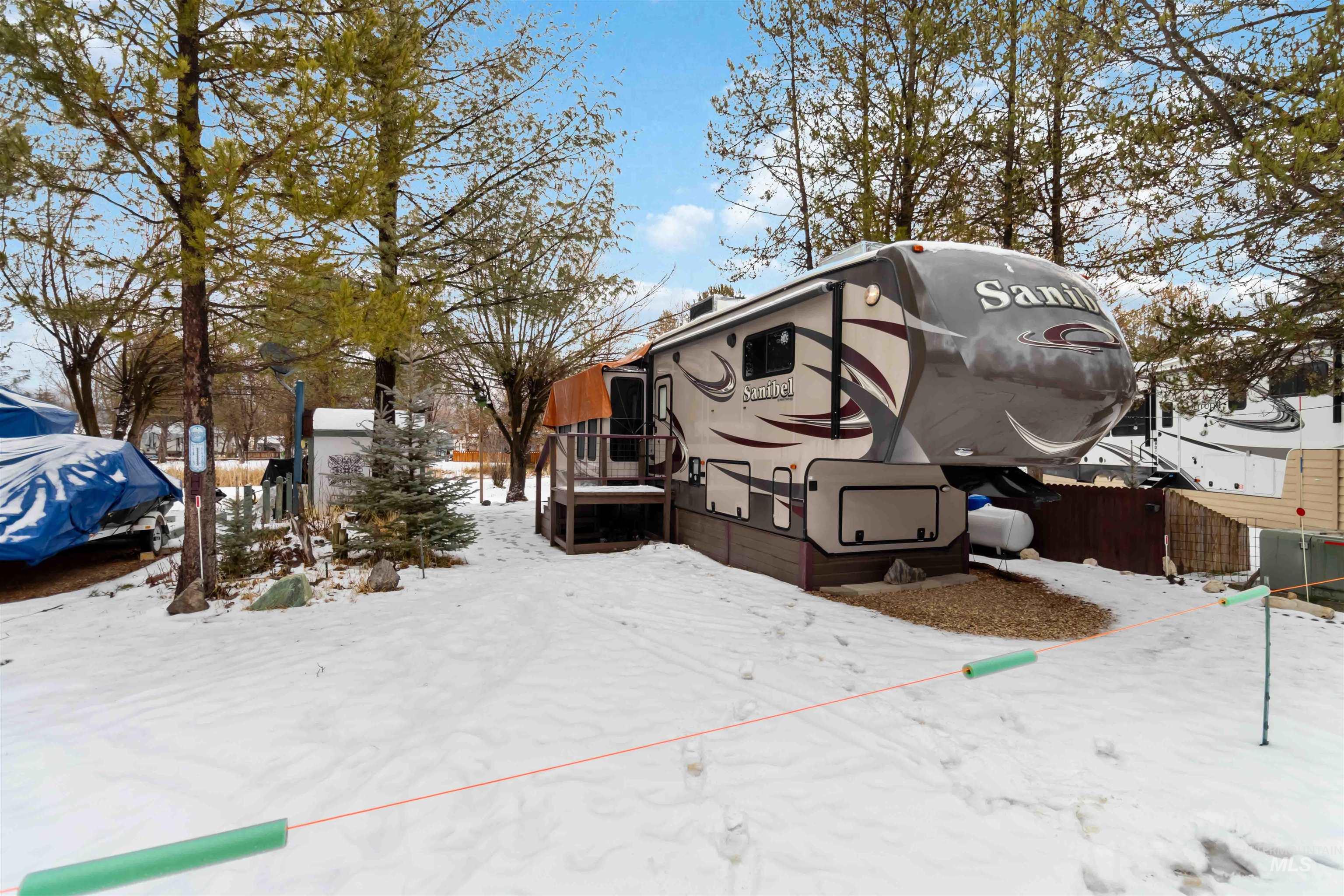 View of snow covered exterior featuring a wooden deck