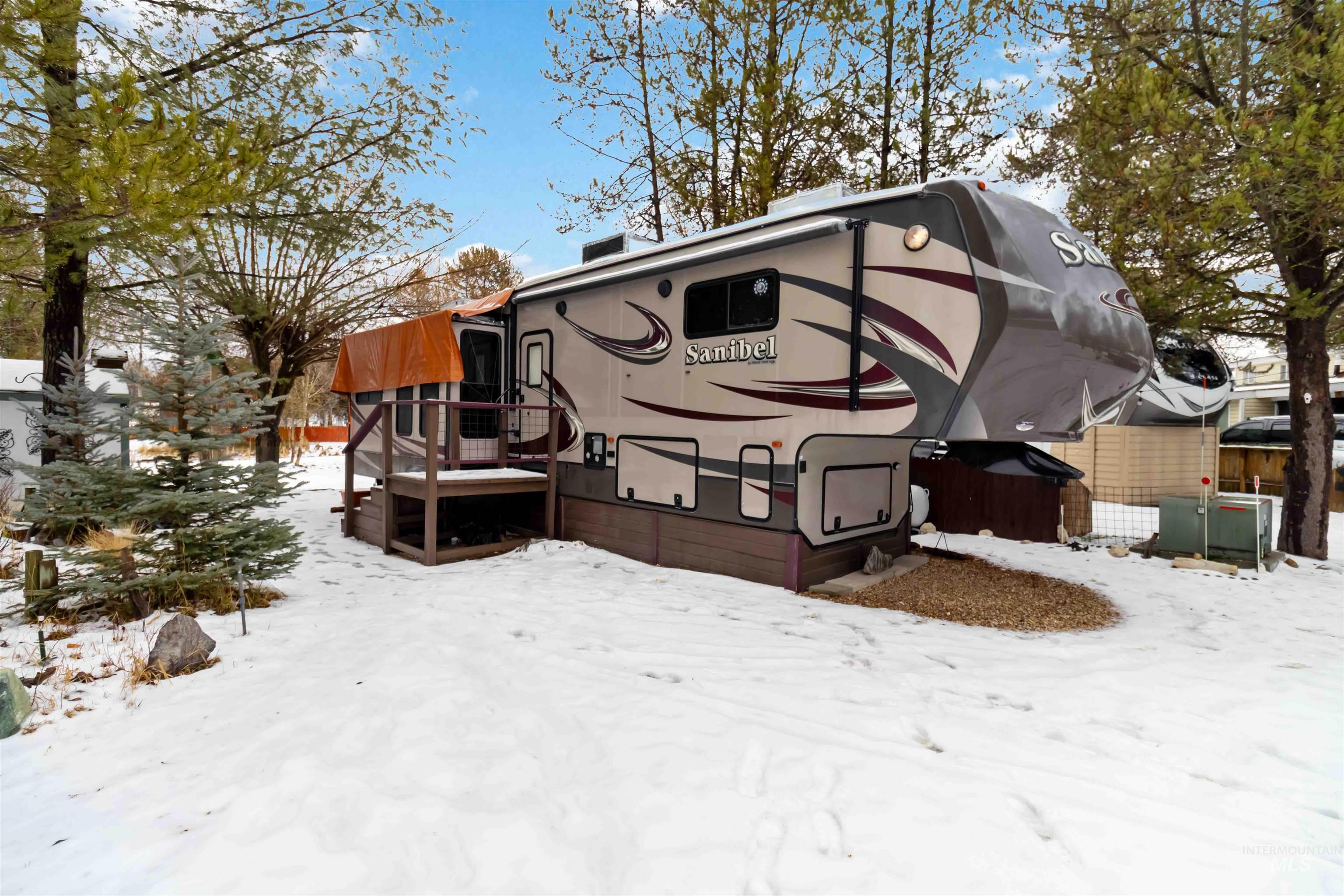 View of snow covered exterior featuring a deck