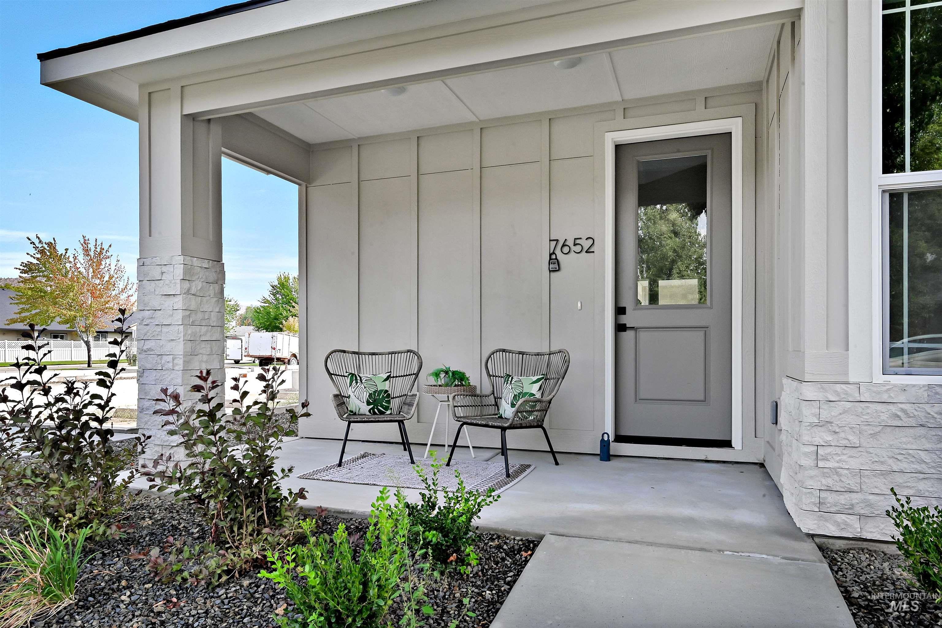 View of exterior entry featuring board and batten siding and a porch