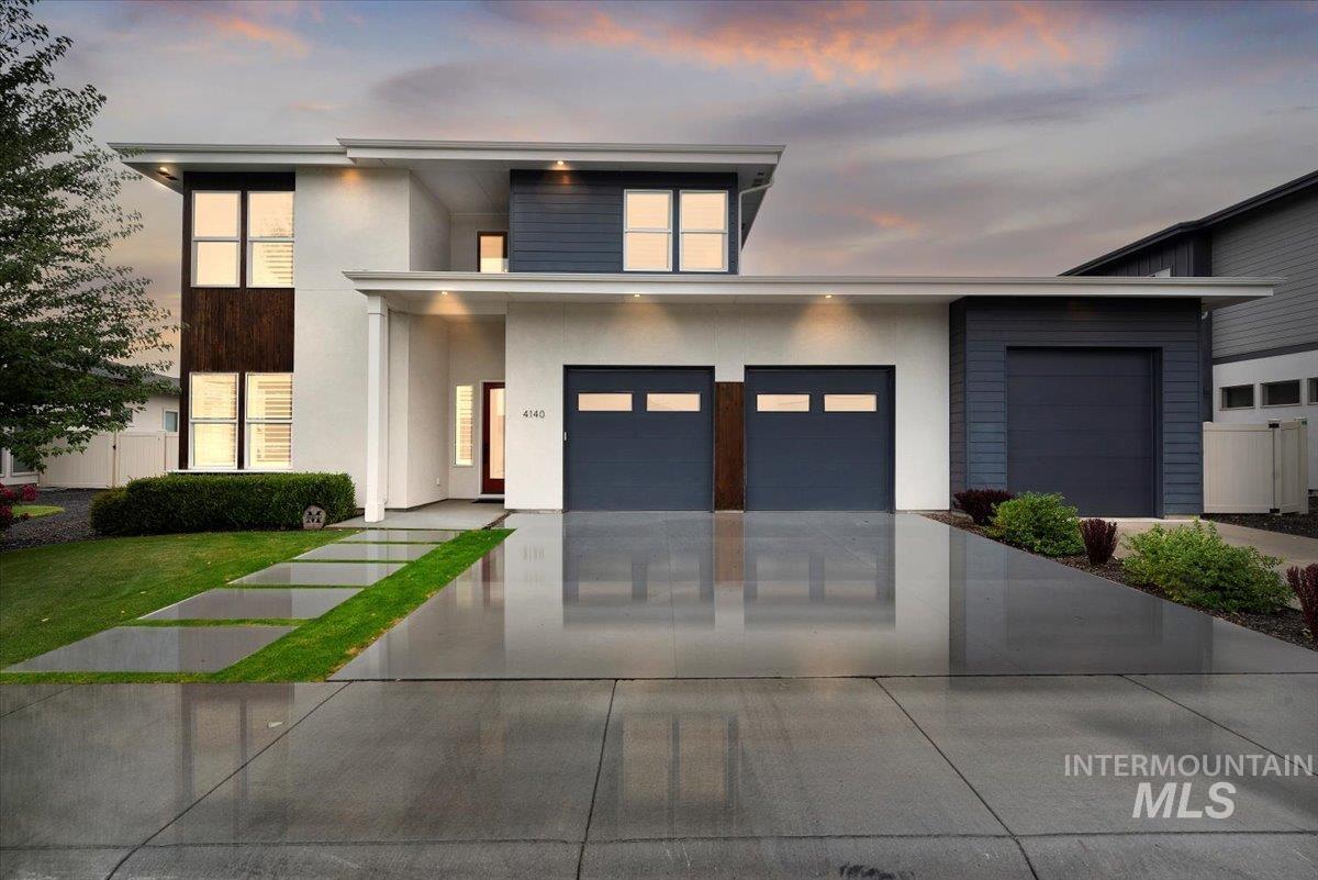 Contemporary house with stucco siding, concrete driveway, and a garage
