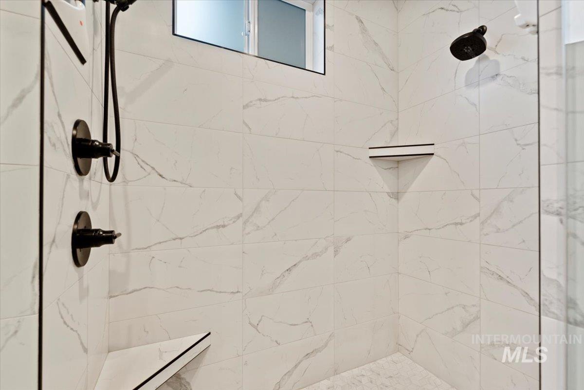 Full bathroom featuring a shower stall