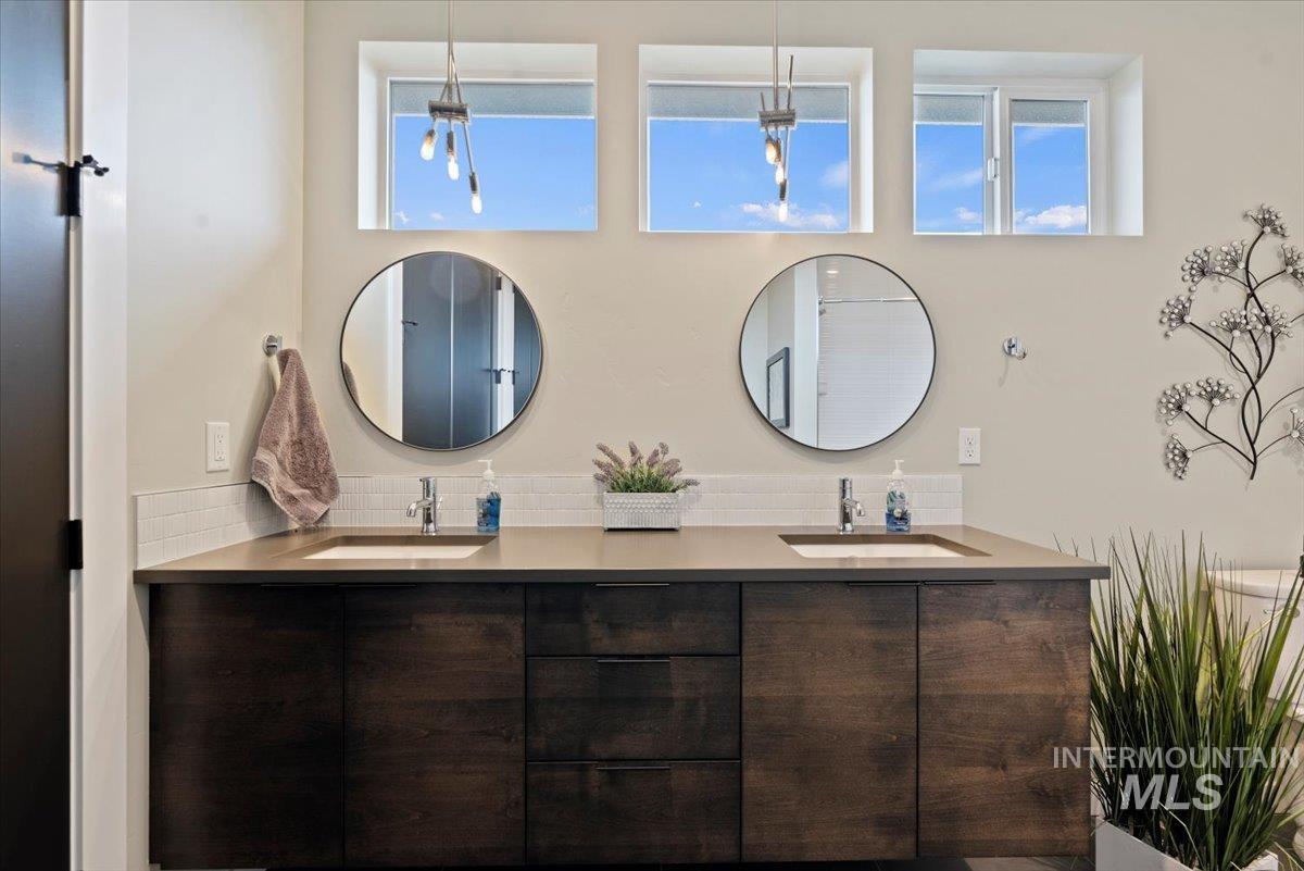 Full bath featuring double vanity