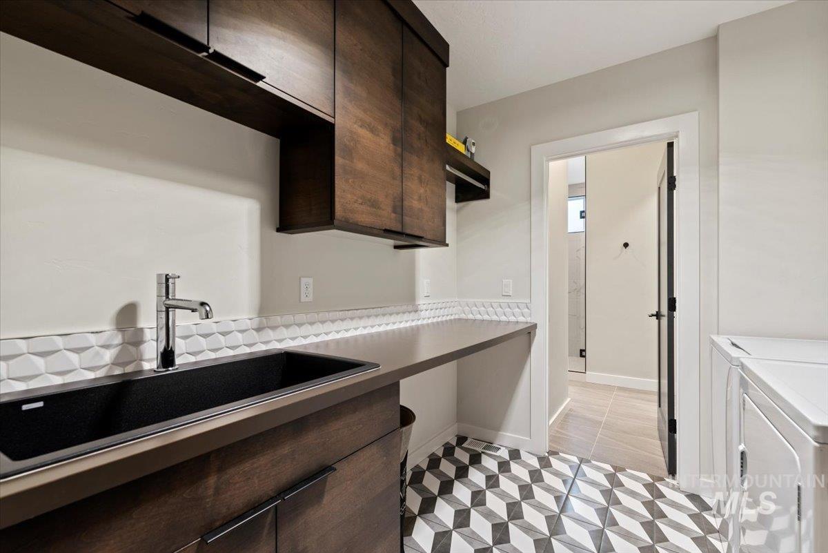 featuring dark brown cabinets, independent washer and dryer, and light countertops