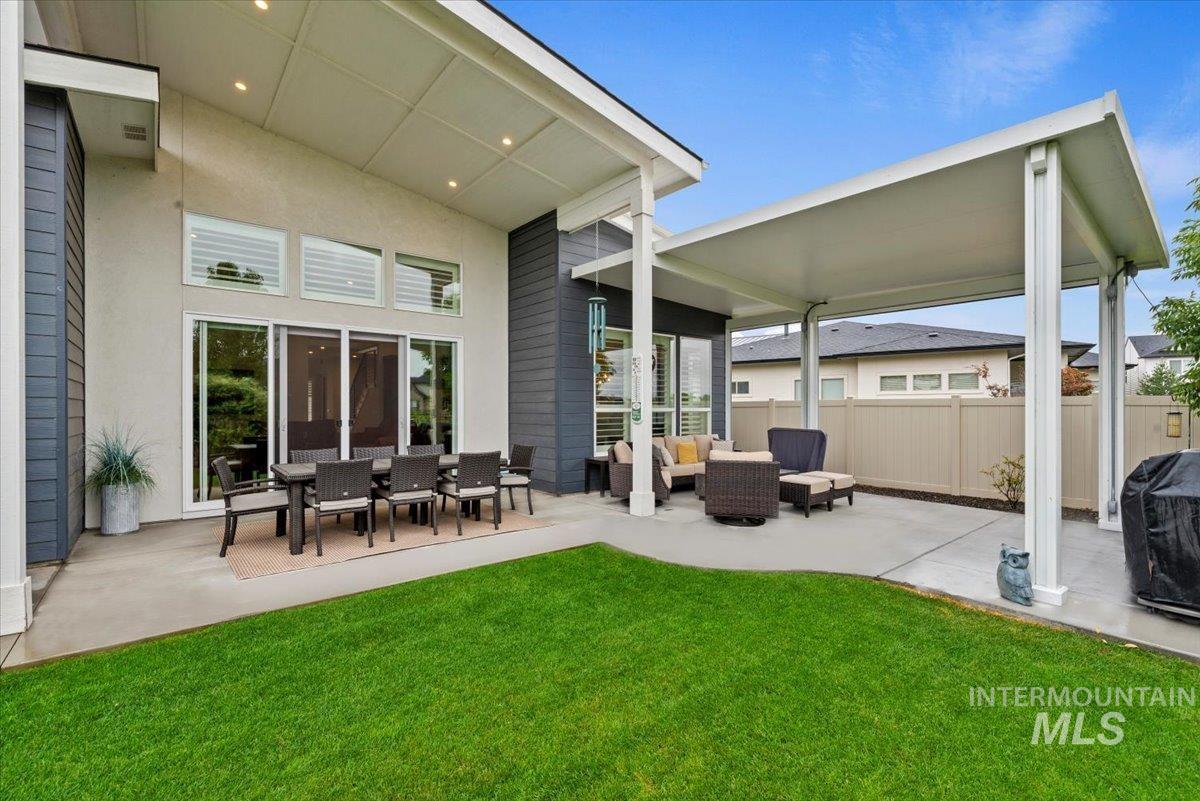 Rear view of house featuring a patio and an outdoor hangout area