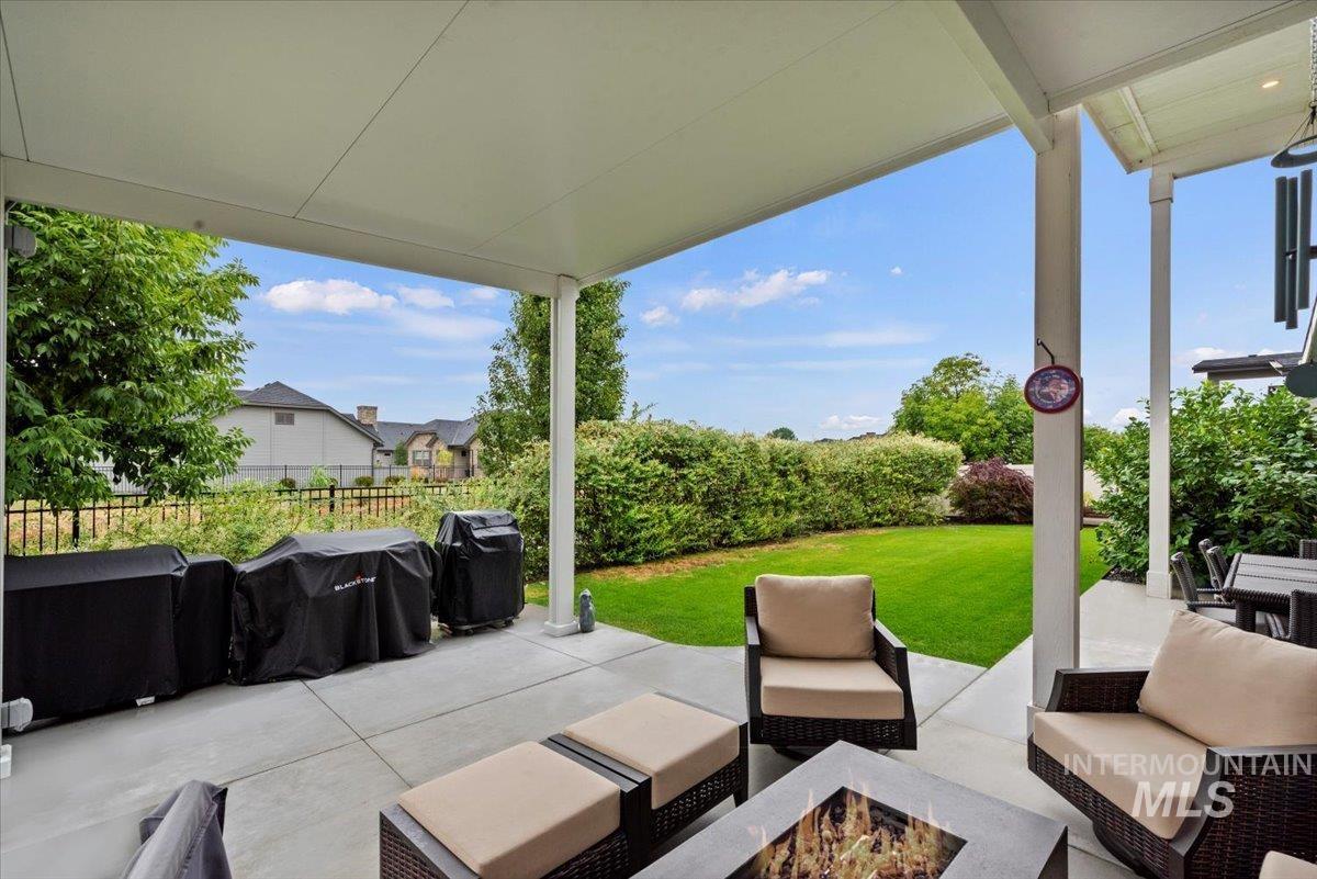 View of patio / terrace featuring an outdoor living space with a fire pit and area for grilling