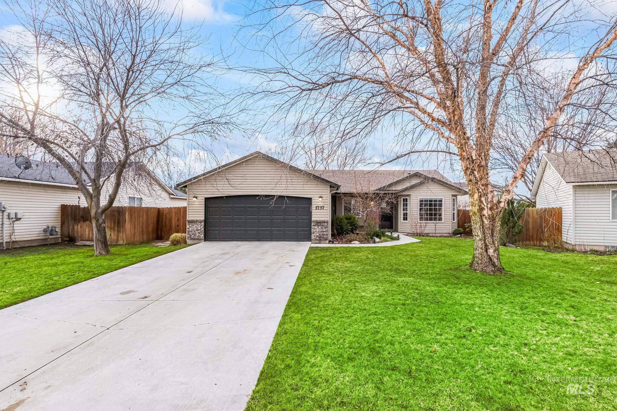 Single story home featuring driveway and an attached garage