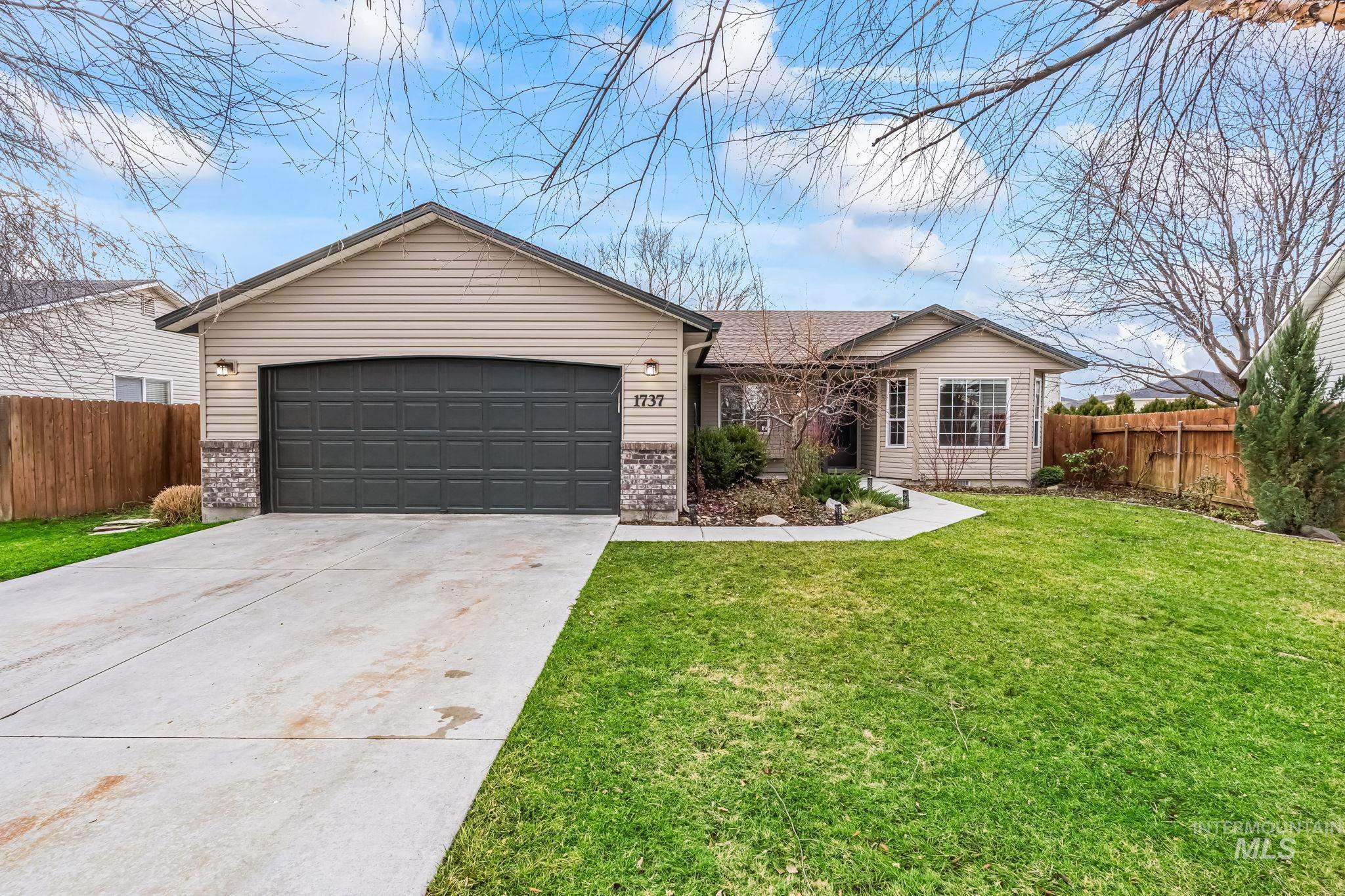 Ranch-style house with concrete driveway, a garage, and brick siding