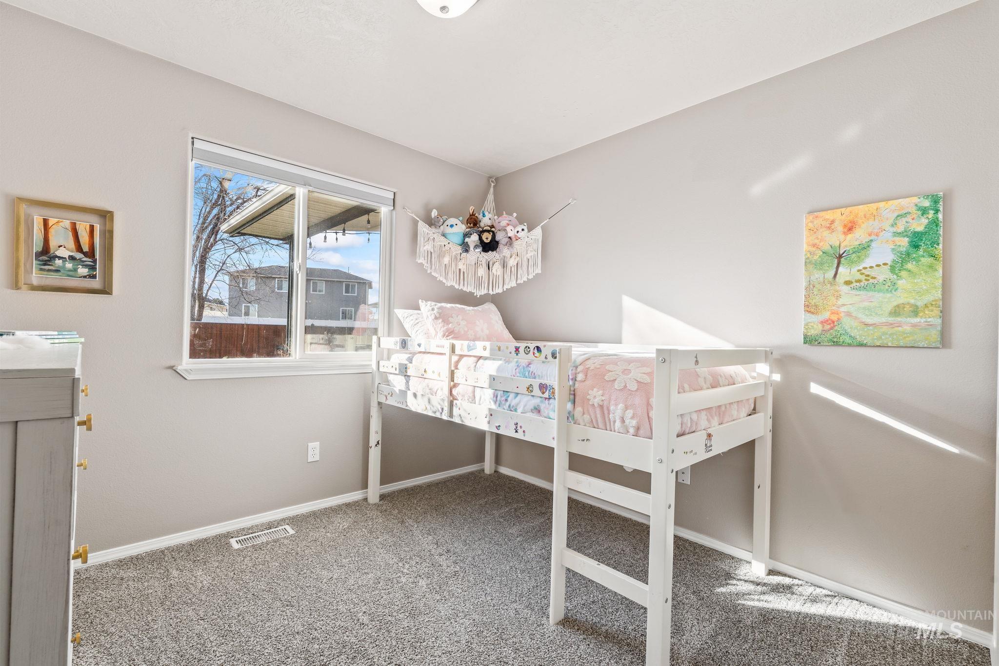 Bedroom with light carpet and baseboards