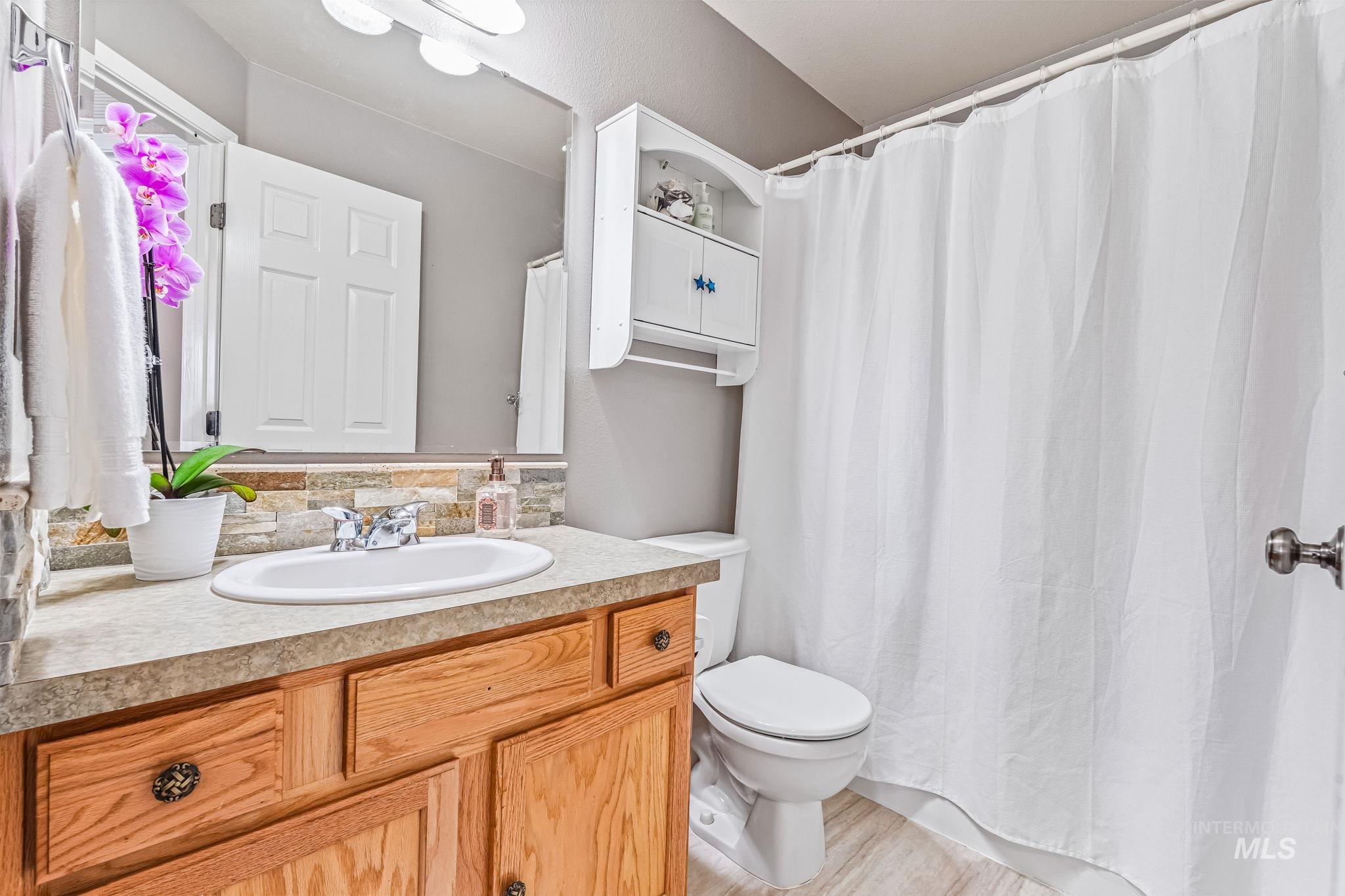 Full bathroom featuring vanity and light wood finished floors