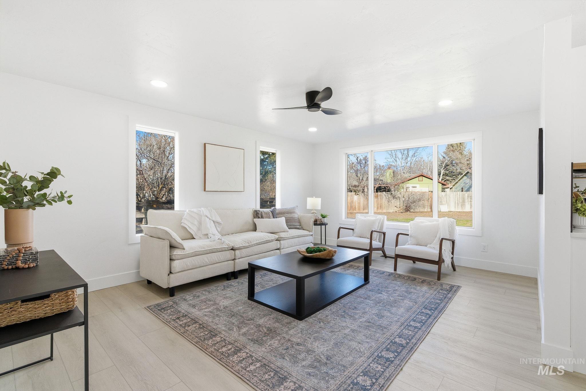 Living area featuring light wood-type flooring, recessed lighting, and ceiling fan