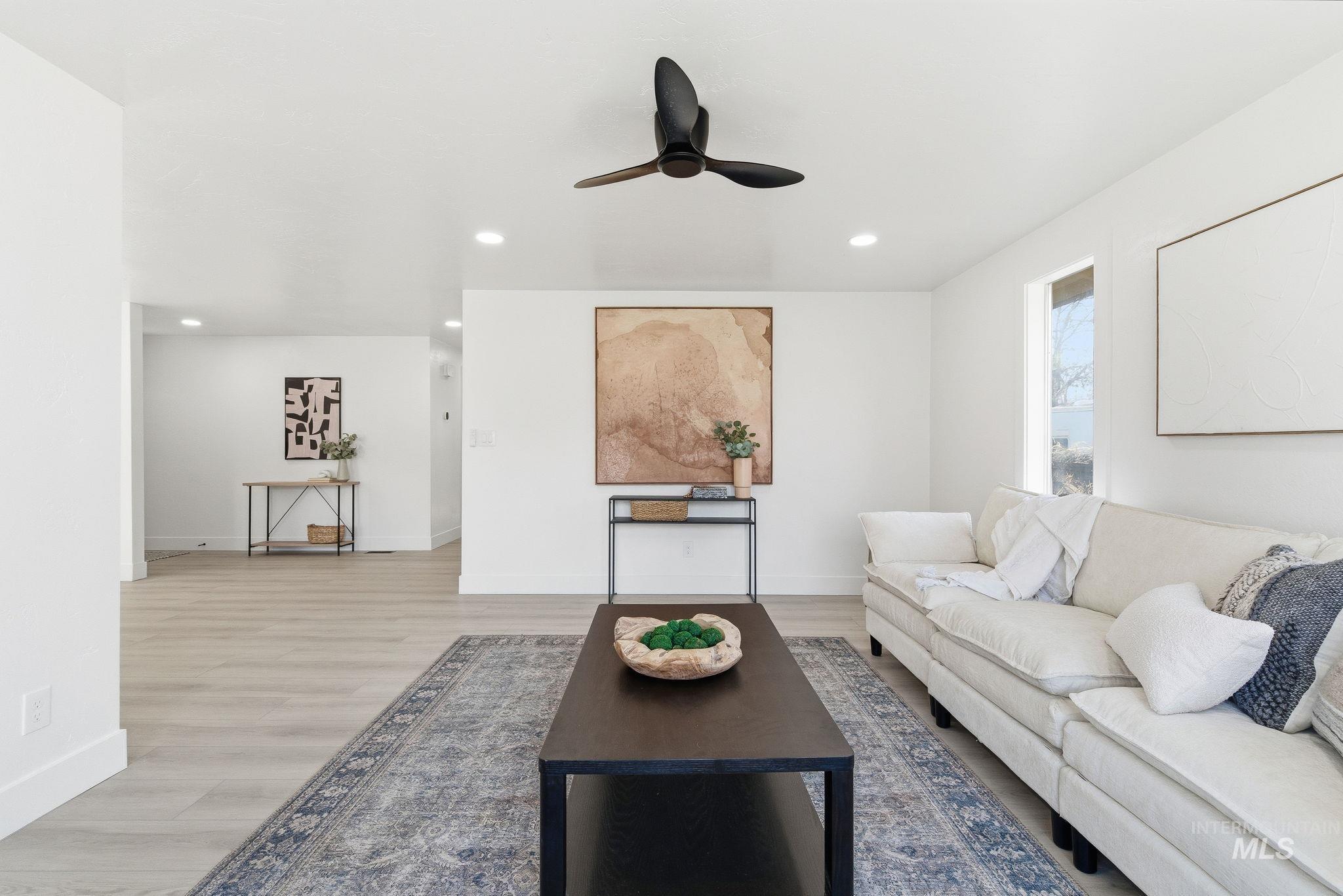 Living area with light wood-type flooring, recessed lighting, and ceiling fan
