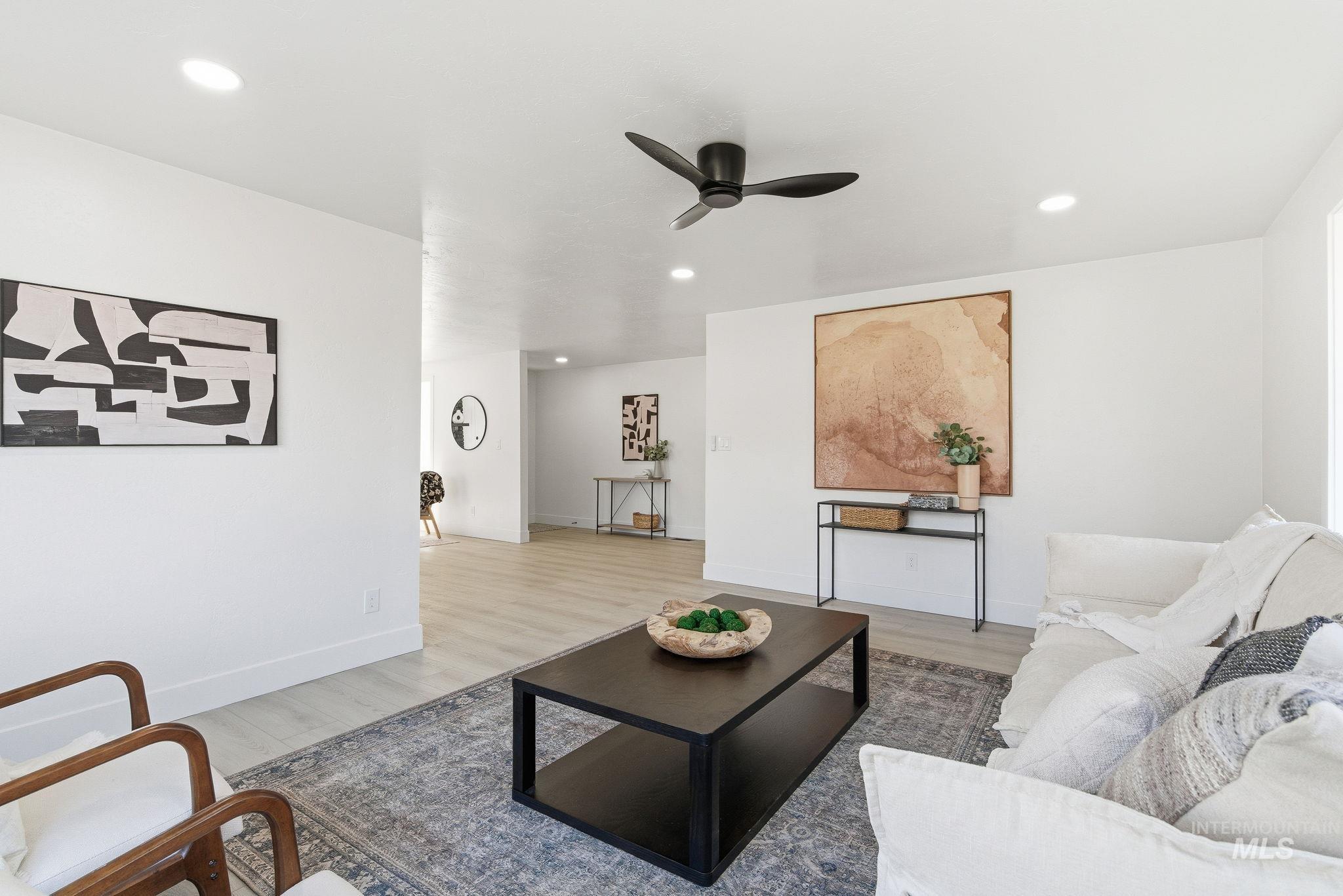 Living area with wood finished floors, recessed lighting, and ceiling fan