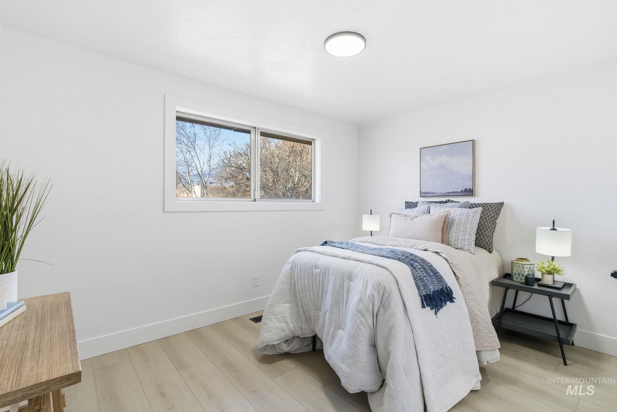 Bedroom featuring baseboards and light wood-style floors