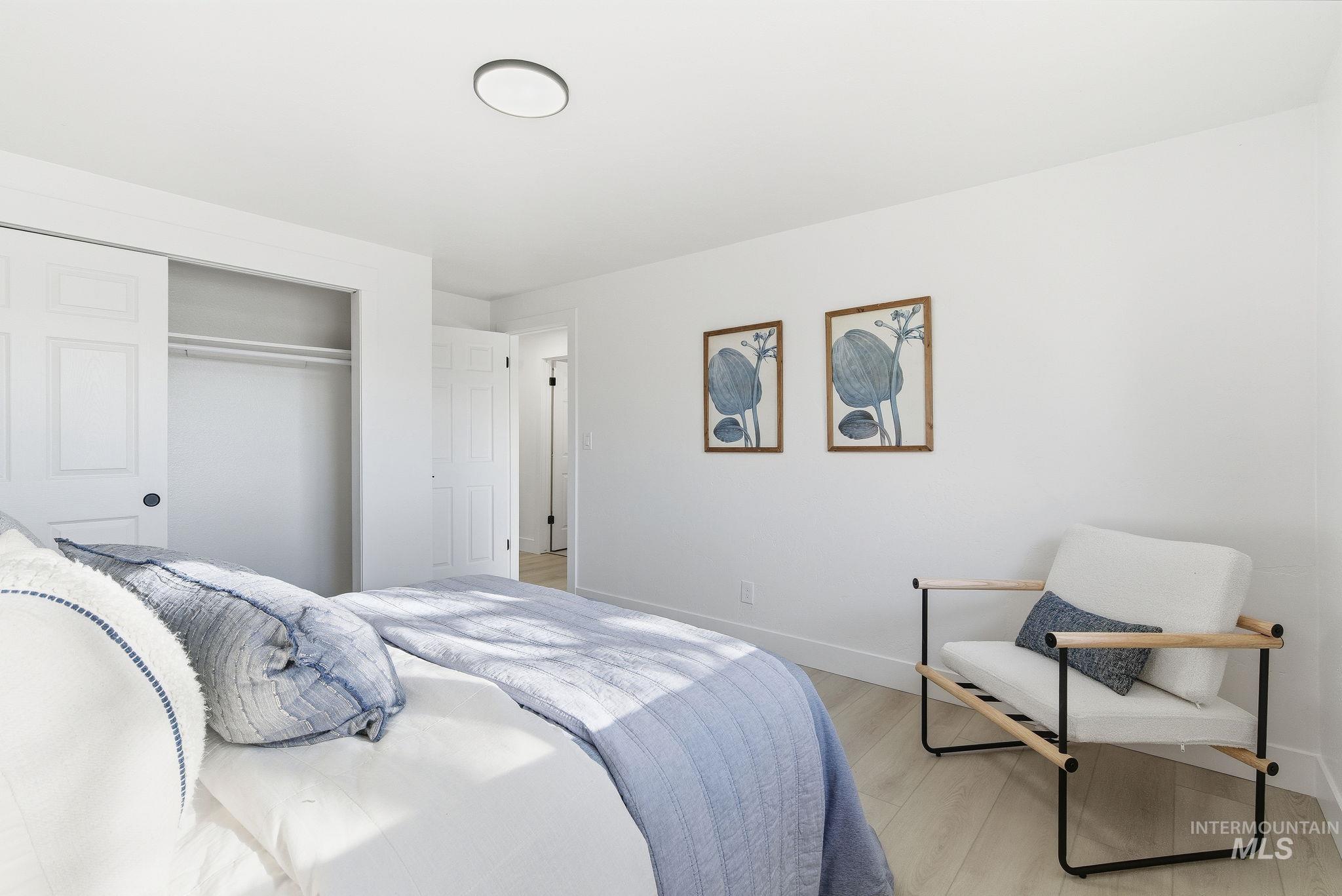 Bedroom featuring a closet and light wood-style floors