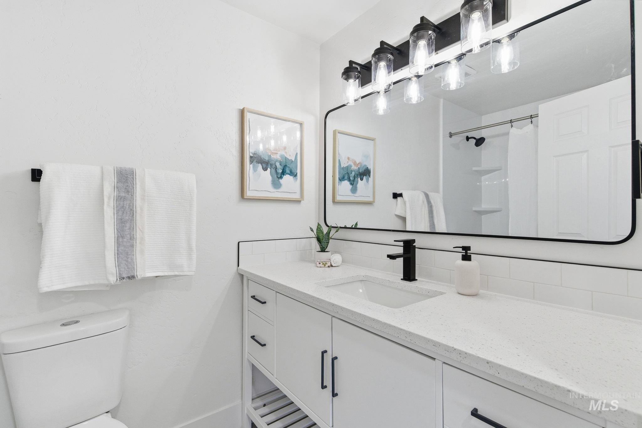 Full bathroom featuring vanity and curtained shower