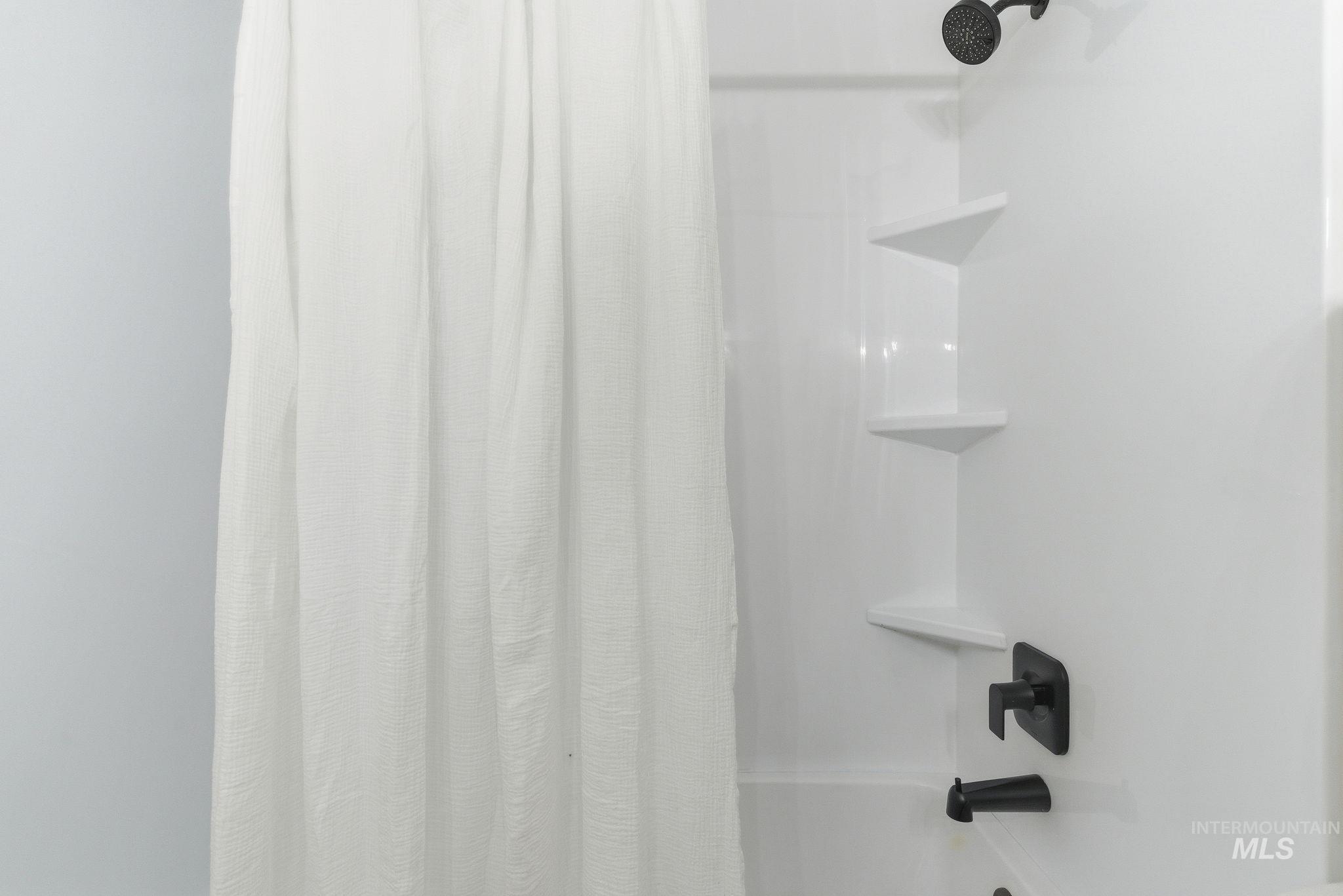Bathroom view of shower / tub combo
