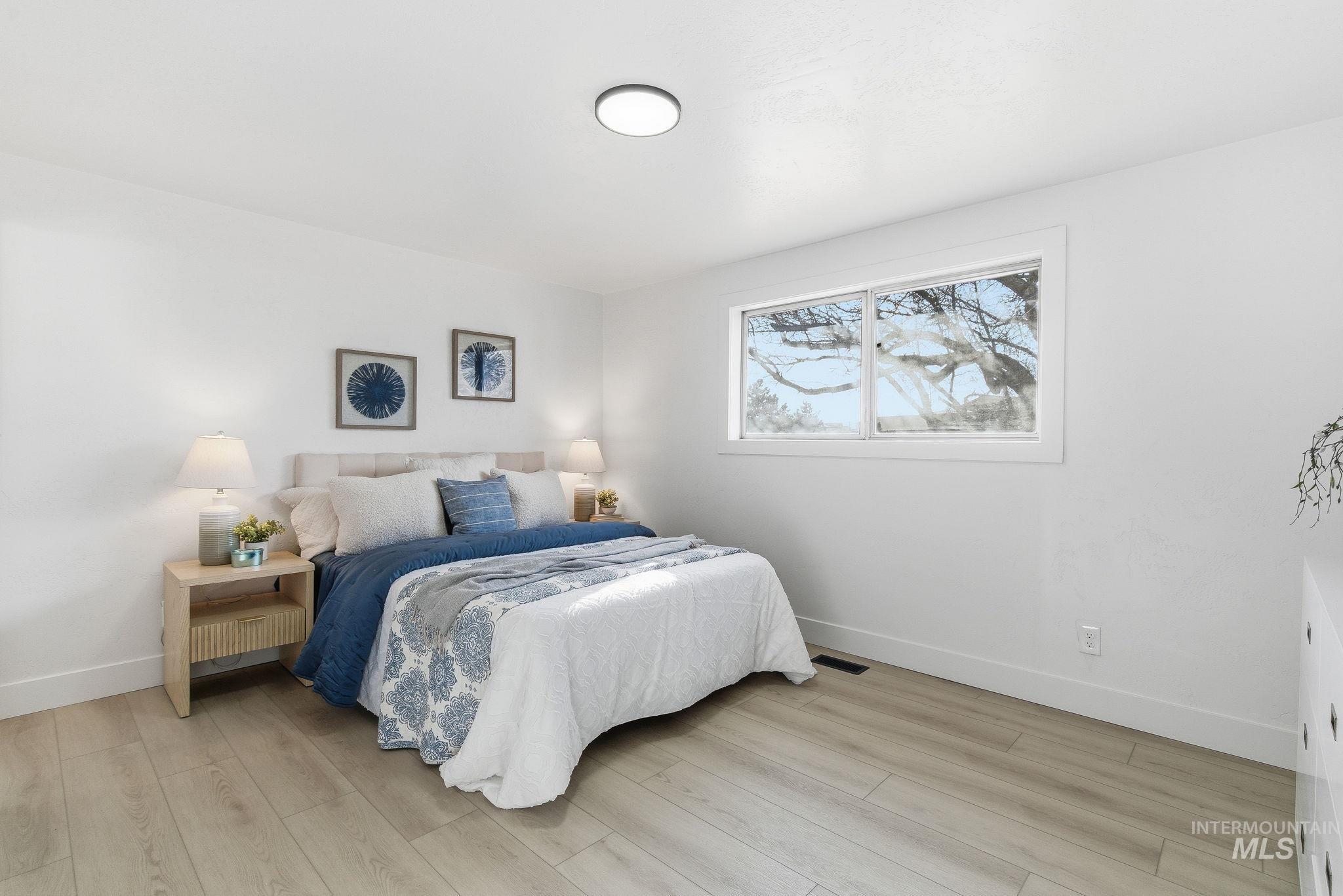 Bedroom with light wood-style floors