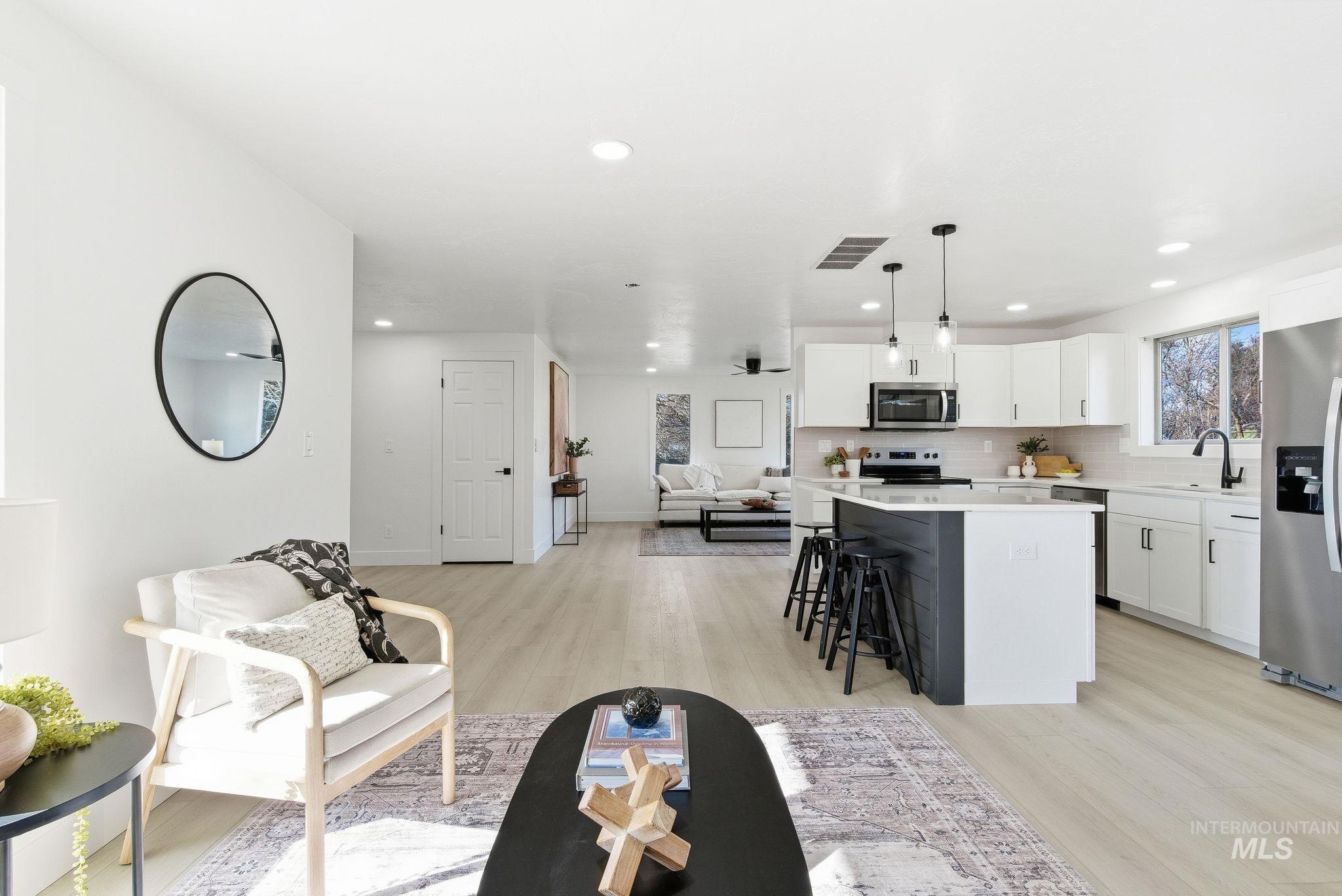 Living room featuring light wood-type flooring and recessed lighting