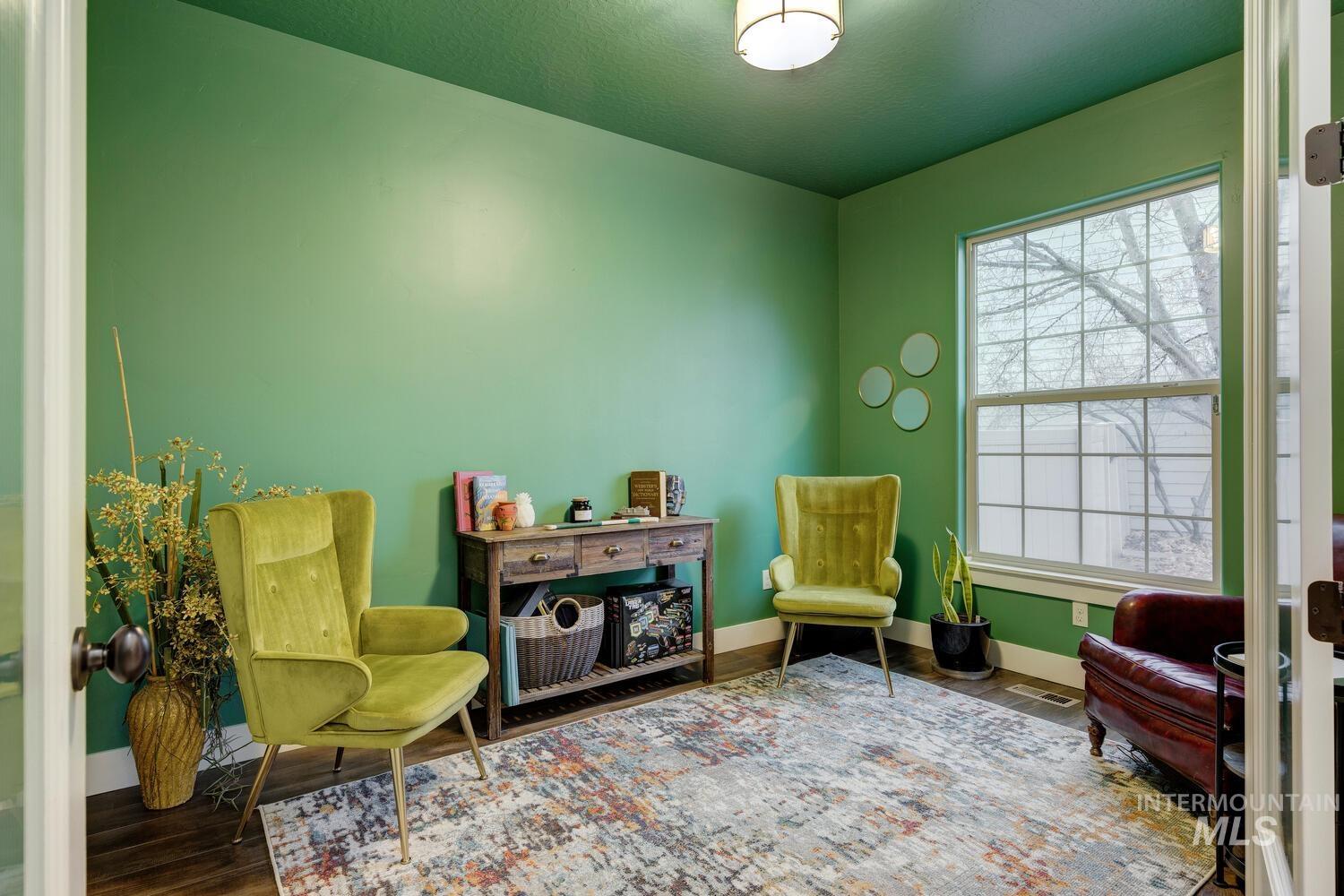 Living area featuring baseboards and wood finished floors