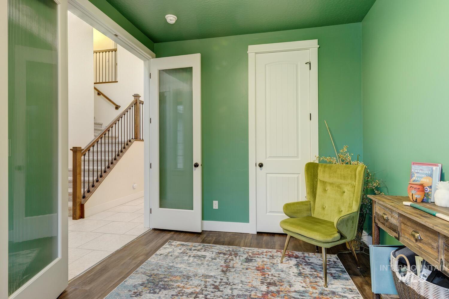 Living area with stairs and dark wood-style flooring