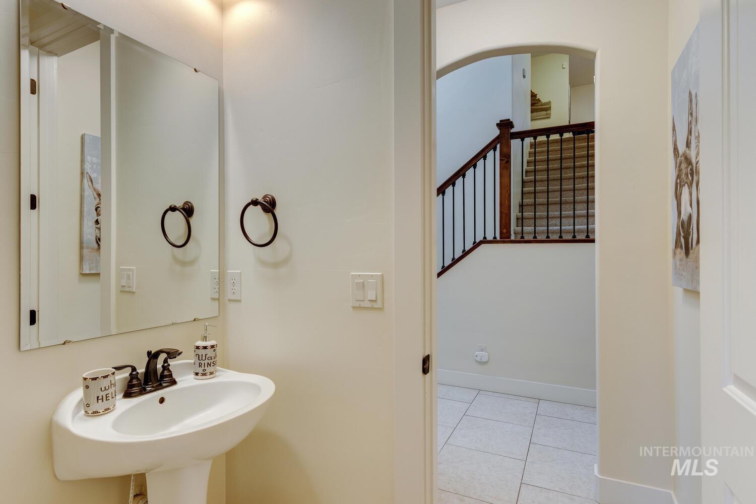 Bathroom featuring light tile patterned floors and baseboards