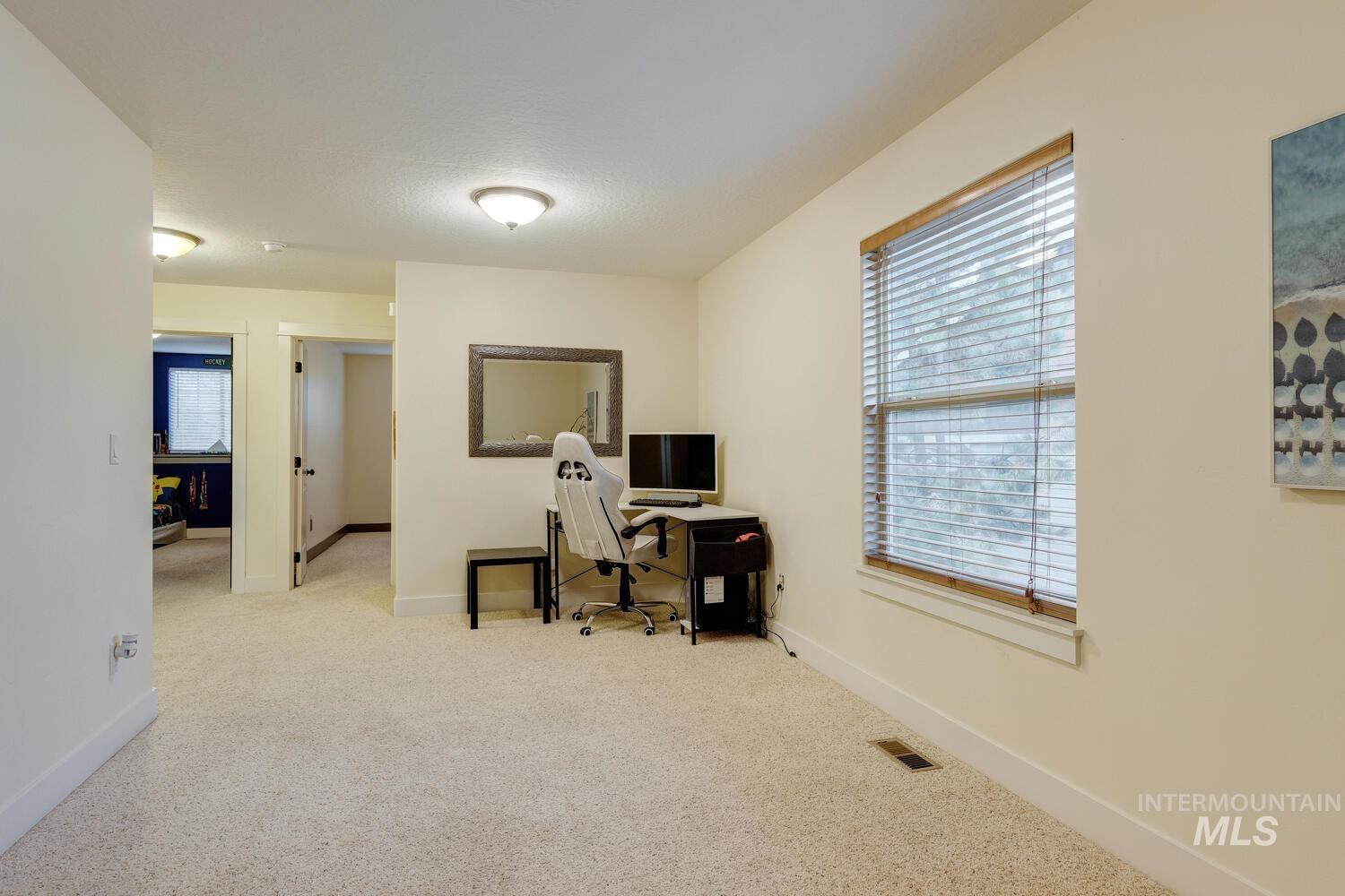 Carpeted office featuring plenty of natural light