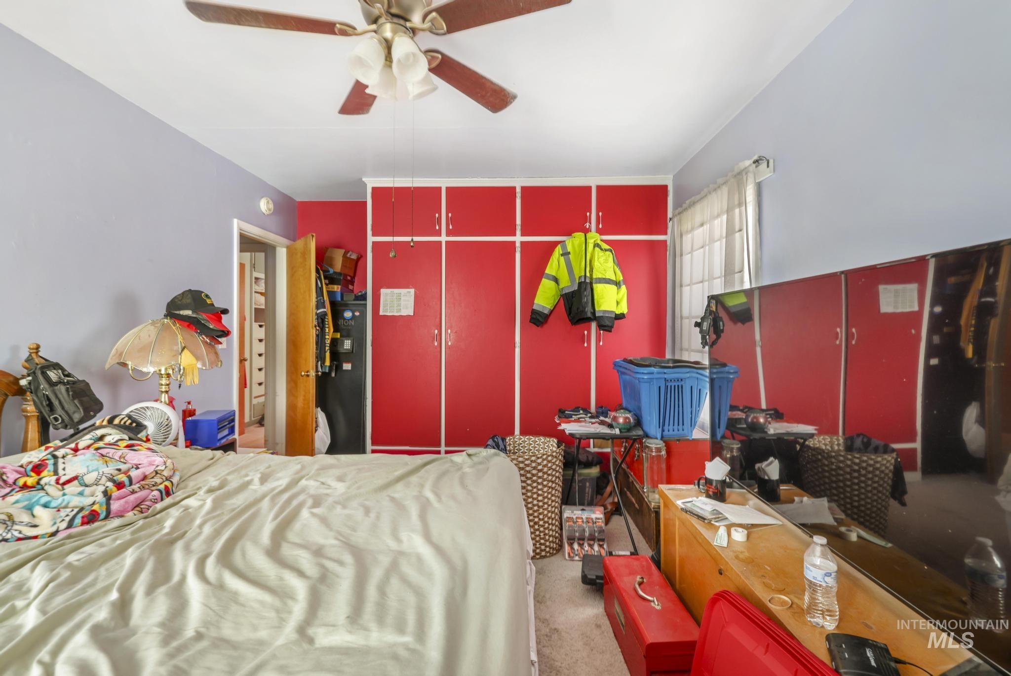 Bedroom with light colored carpet and ceiling fan