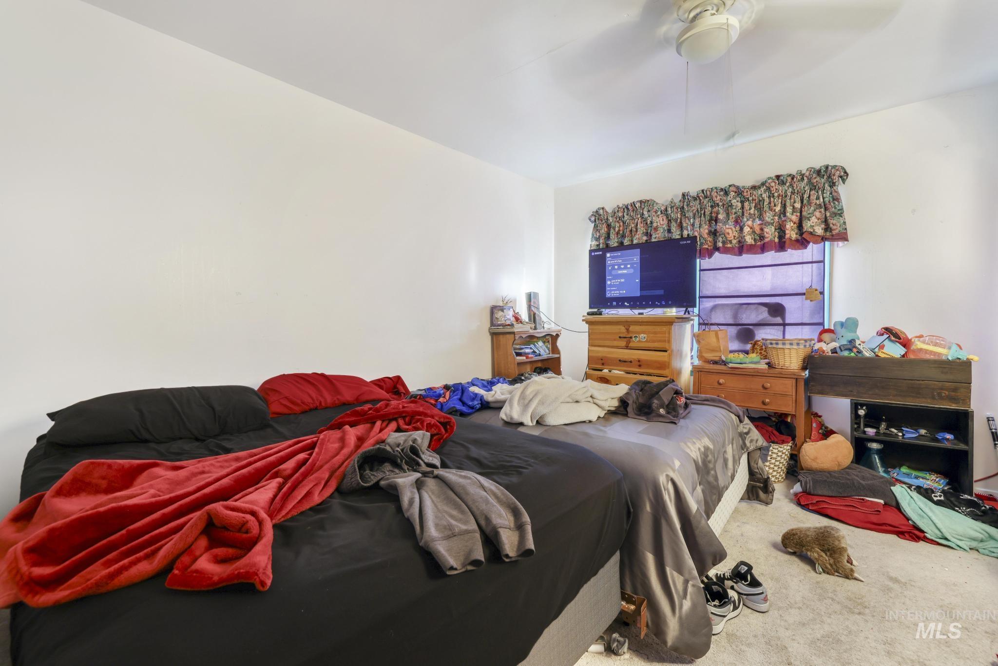 Bedroom with carpet flooring and ceiling fan