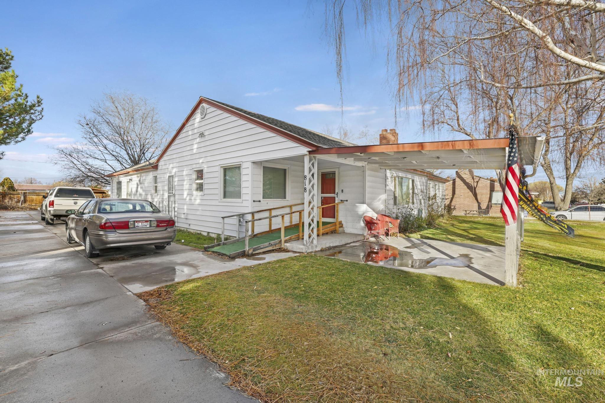 Bungalow-style home featuring a front yard and a chimney