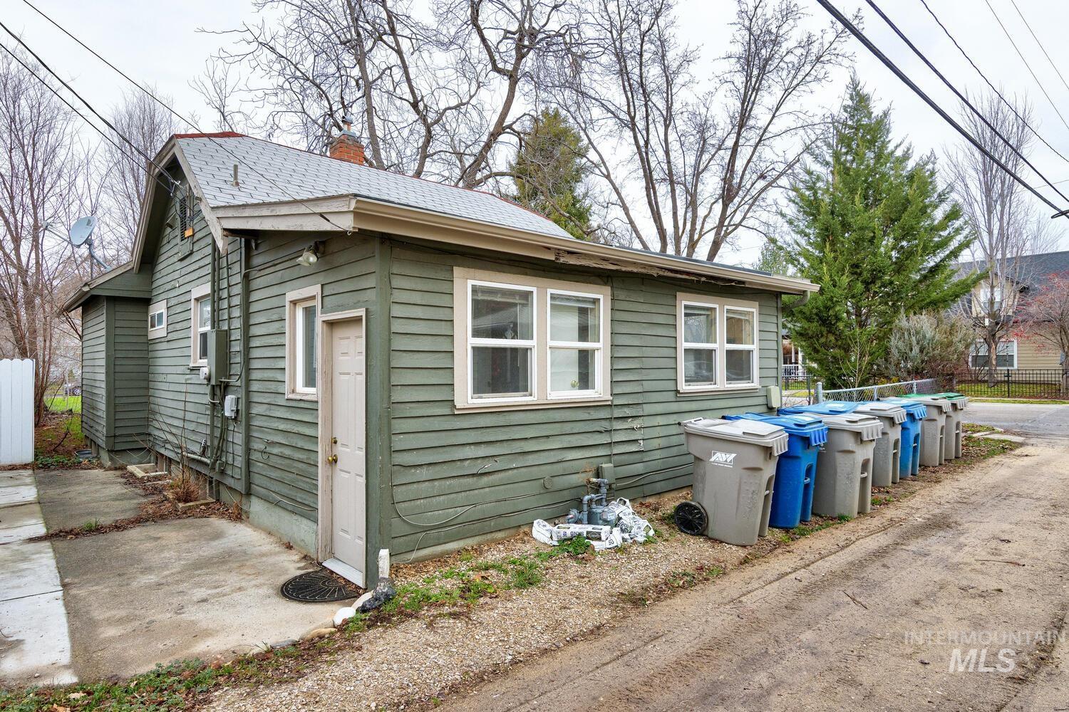 View of home's exterior featuring a chimney and a patio area