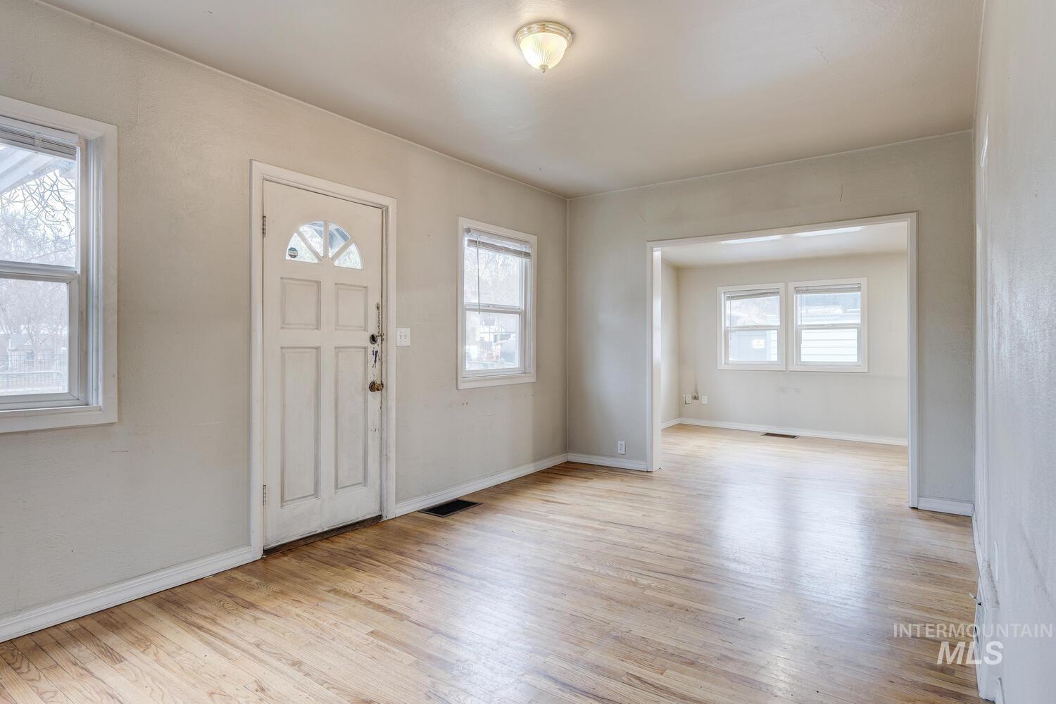 Entrance foyer with light wood-style flooring and baseboards