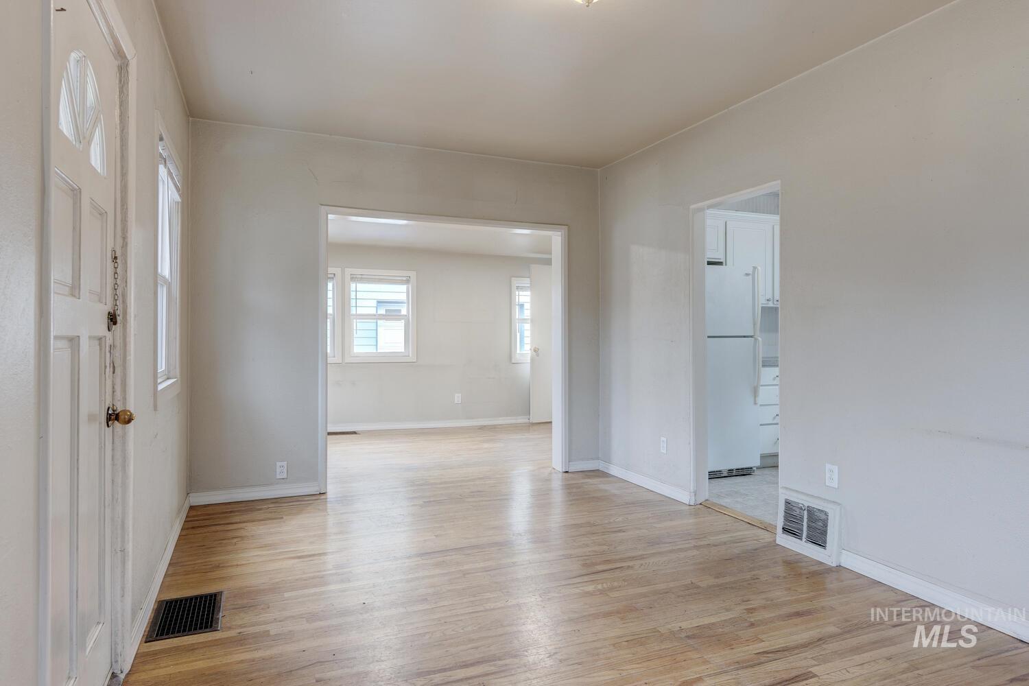 Empty room featuring light wood-type flooring