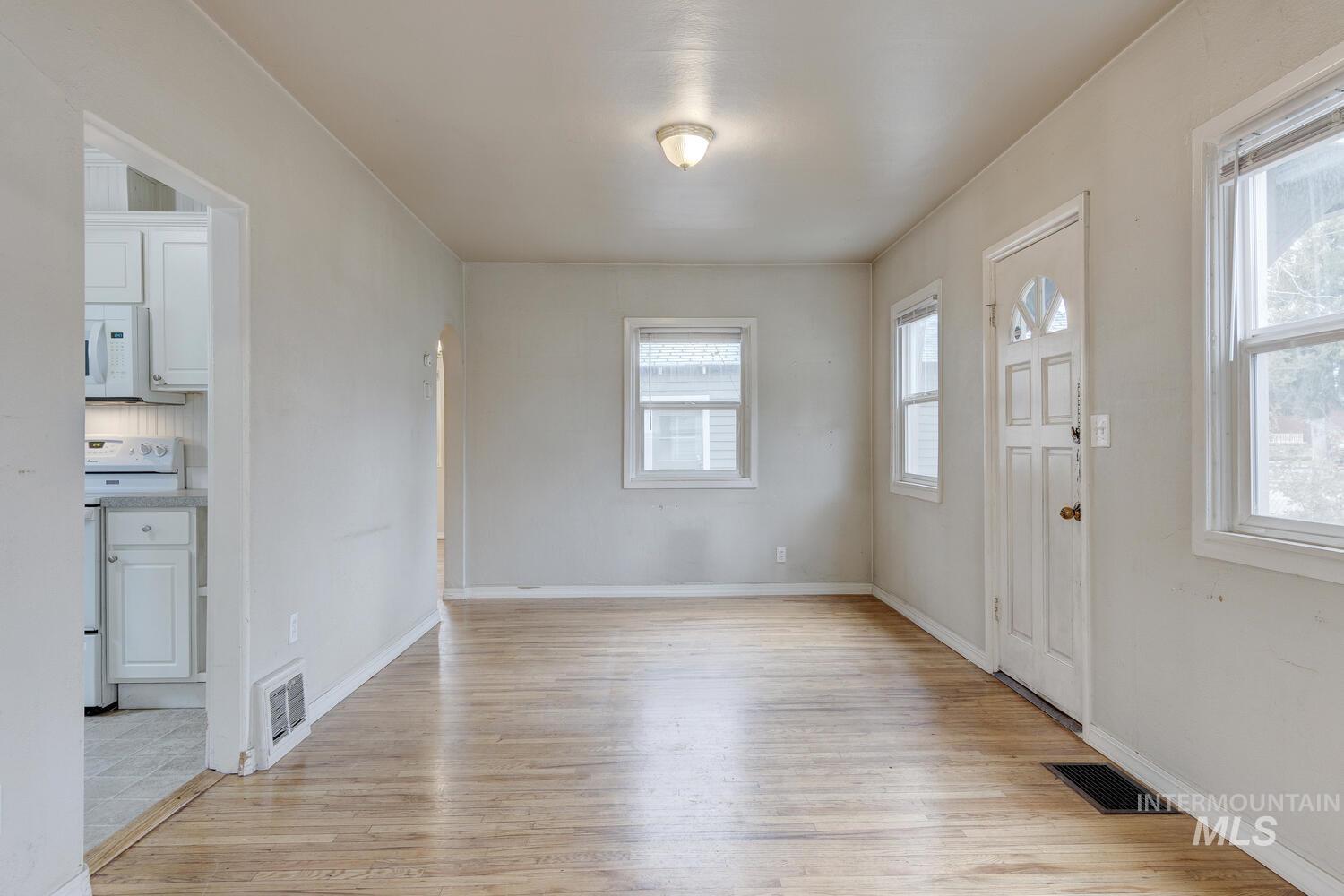 Entryway with light wood-style floors and baseboards