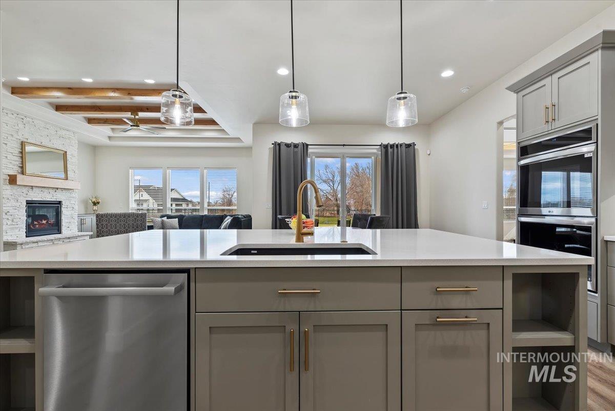 Kitchen with gray cabinetry, open shelves, stainless steel appliances, pendant lighting, and recessed lighting