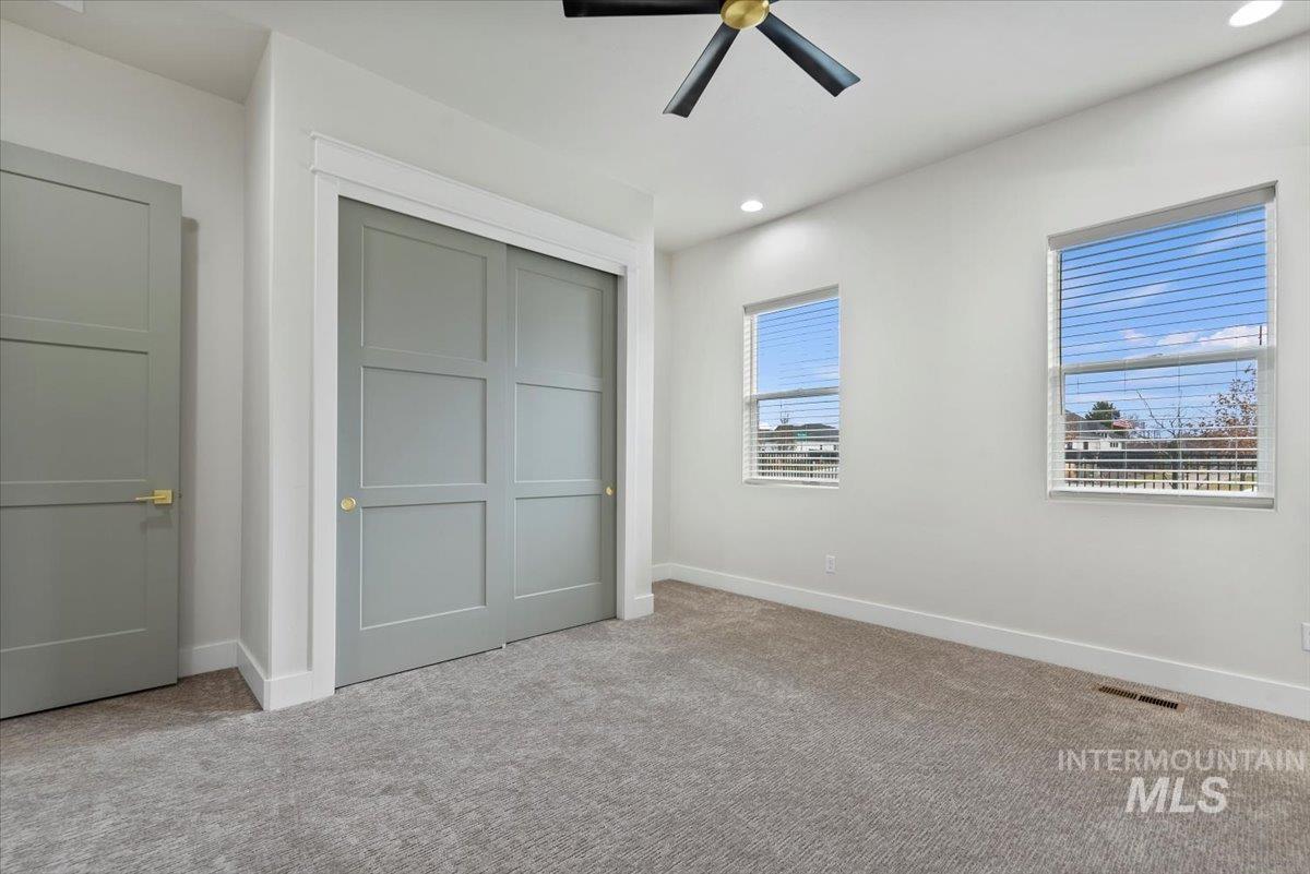 Unfurnished bedroom with a closet, carpet flooring, recessed lighting, and a ceiling fan