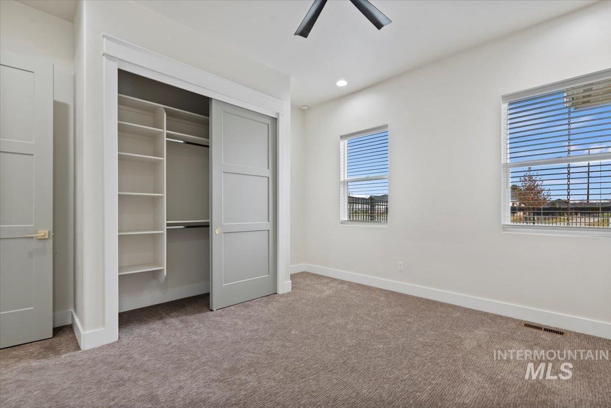 Unfurnished bedroom with a closet, carpet flooring, recessed lighting, and ceiling fan