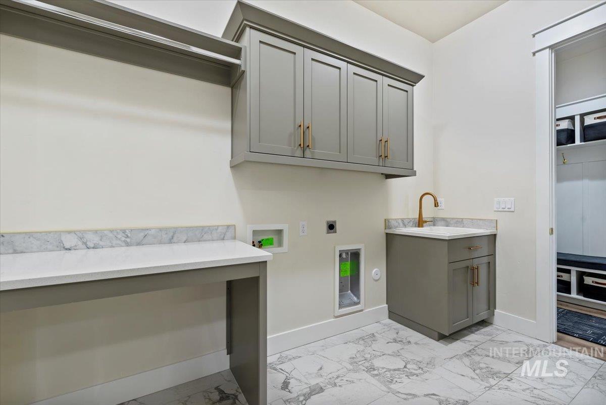 Laundry area featuring light marble finish flooring, electric dryer hookup, and washer hookup