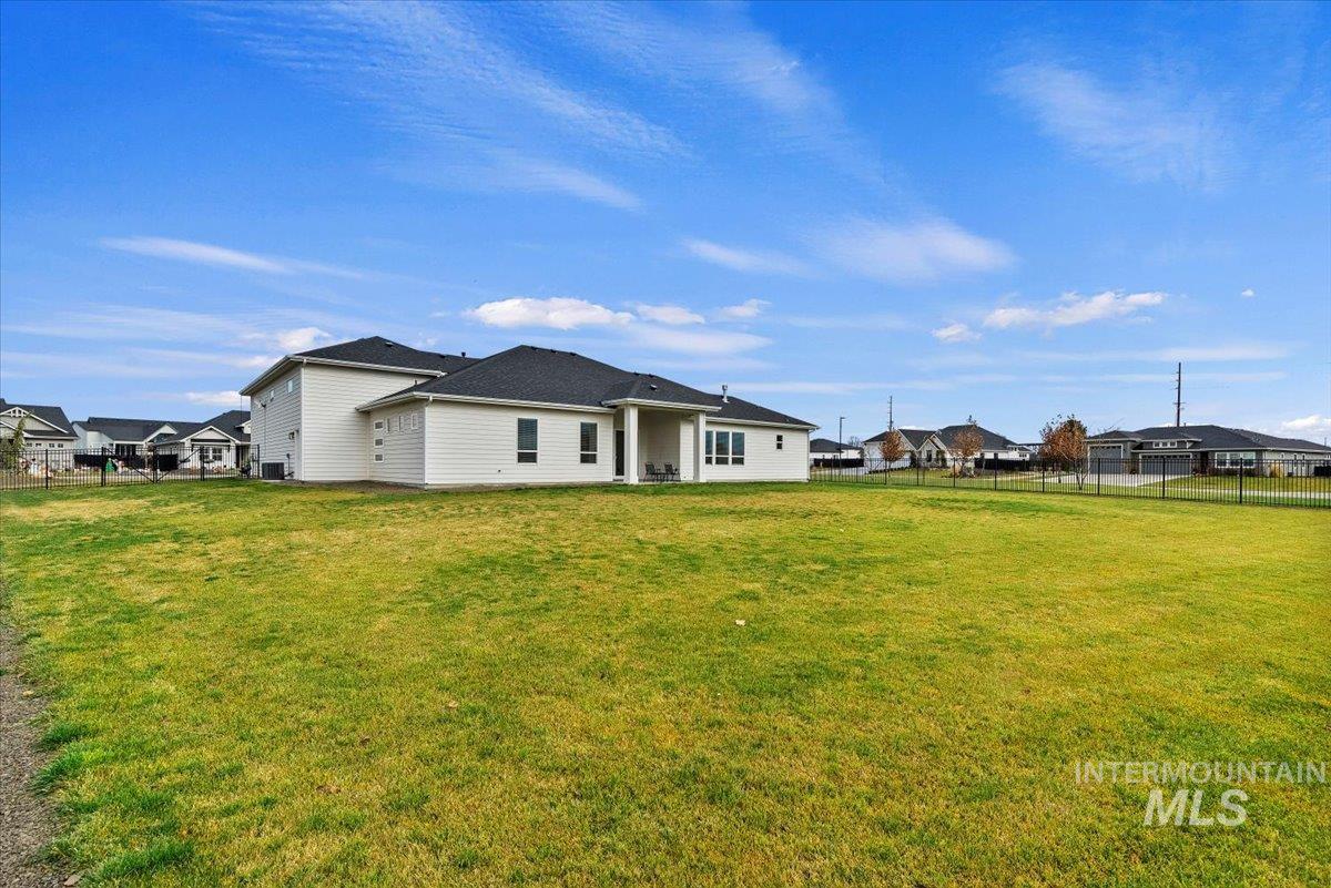 Rear view of property featuring a residential view and a patio
