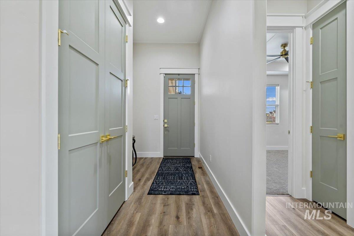 Entryway featuring wood finished floors, plenty of natural light, and recessed lighting