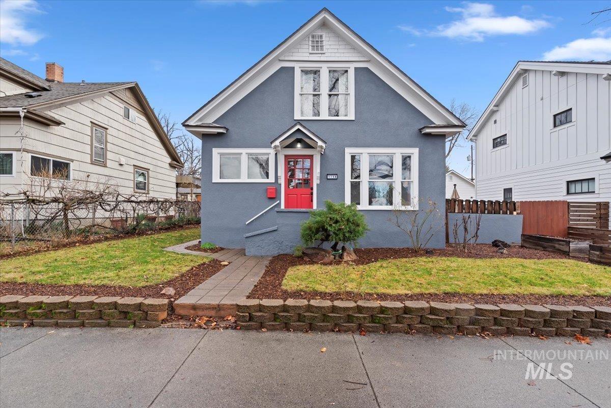 Bungalow-style home with stucco siding