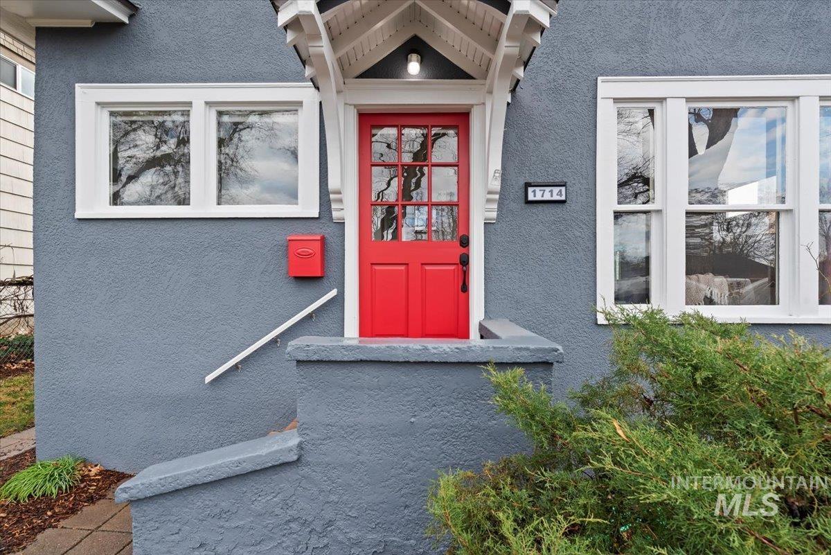 Doorway to property with stucco siding