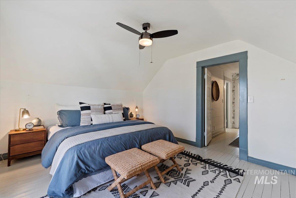 Bedroom featuring vaulted ceiling, a ceiling fan, and light wood-type flooring