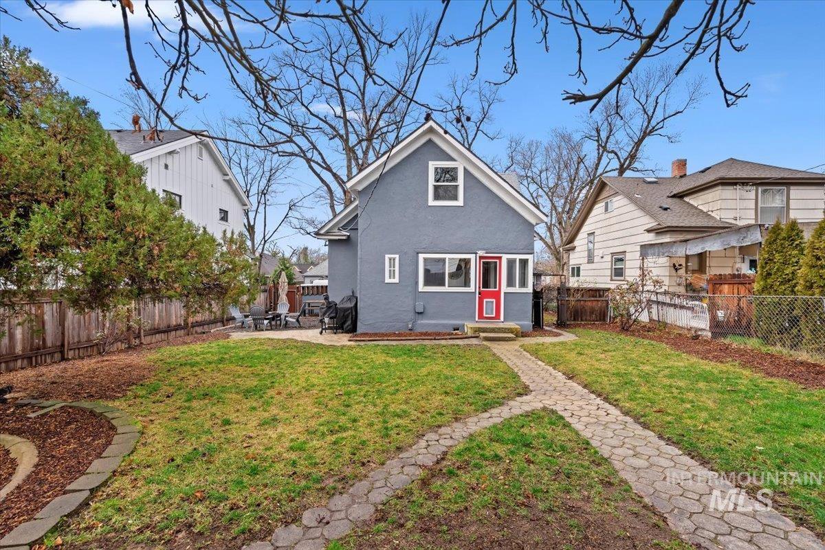 Rear view of property featuring a fenced backyard, stucco siding, and a patio